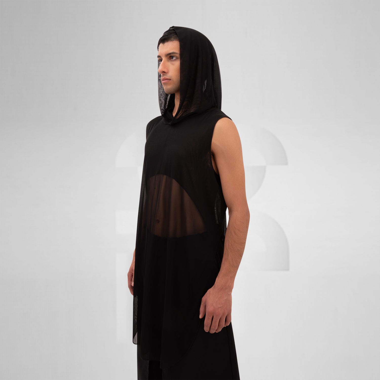 The Mesh Avant-Garde Shirt with Hood from This is Fred offers a bold and innovative design that stands out in any fashion landscape. This unique piece features a lightweight mesh fabric that drapes beautifully, providing both comfort and a striking aesthetic. The hood adds an edgy twist, making it perfect for the techno dance floor or as a statement piece for your street style.