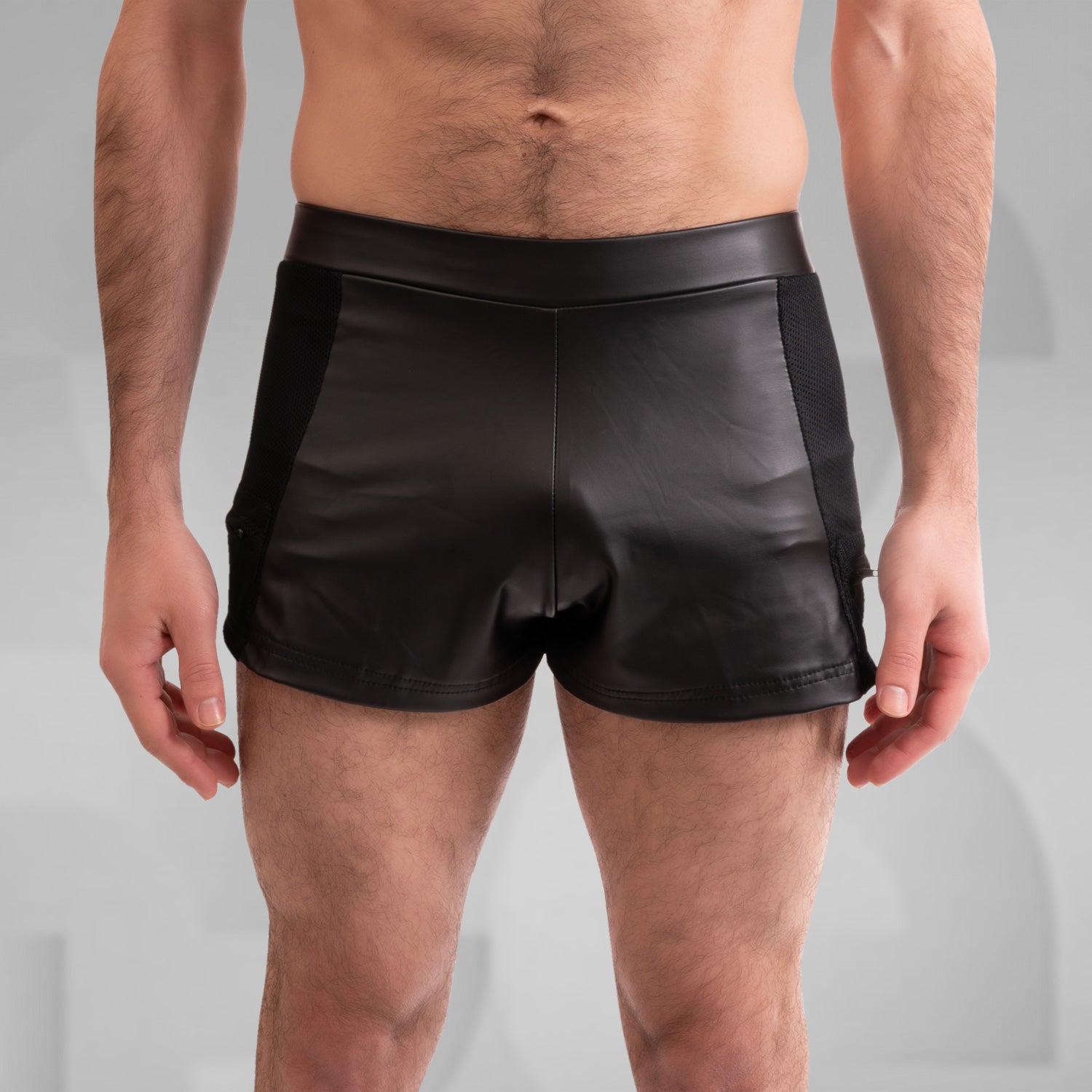 The image showcases a pair of striking black shorts that blend edgy design with functionality. Crafted from sleek, high-quality material, these shorts feature mesh side panels for enhanced breathability and a modern look. With a tailored fit that highlights the physique, they are perfect for both clubwear and casual outings, making a bold statement for anyone looking to embrace their unique style. Ideal for dancing the night away or making an impression in any setting!