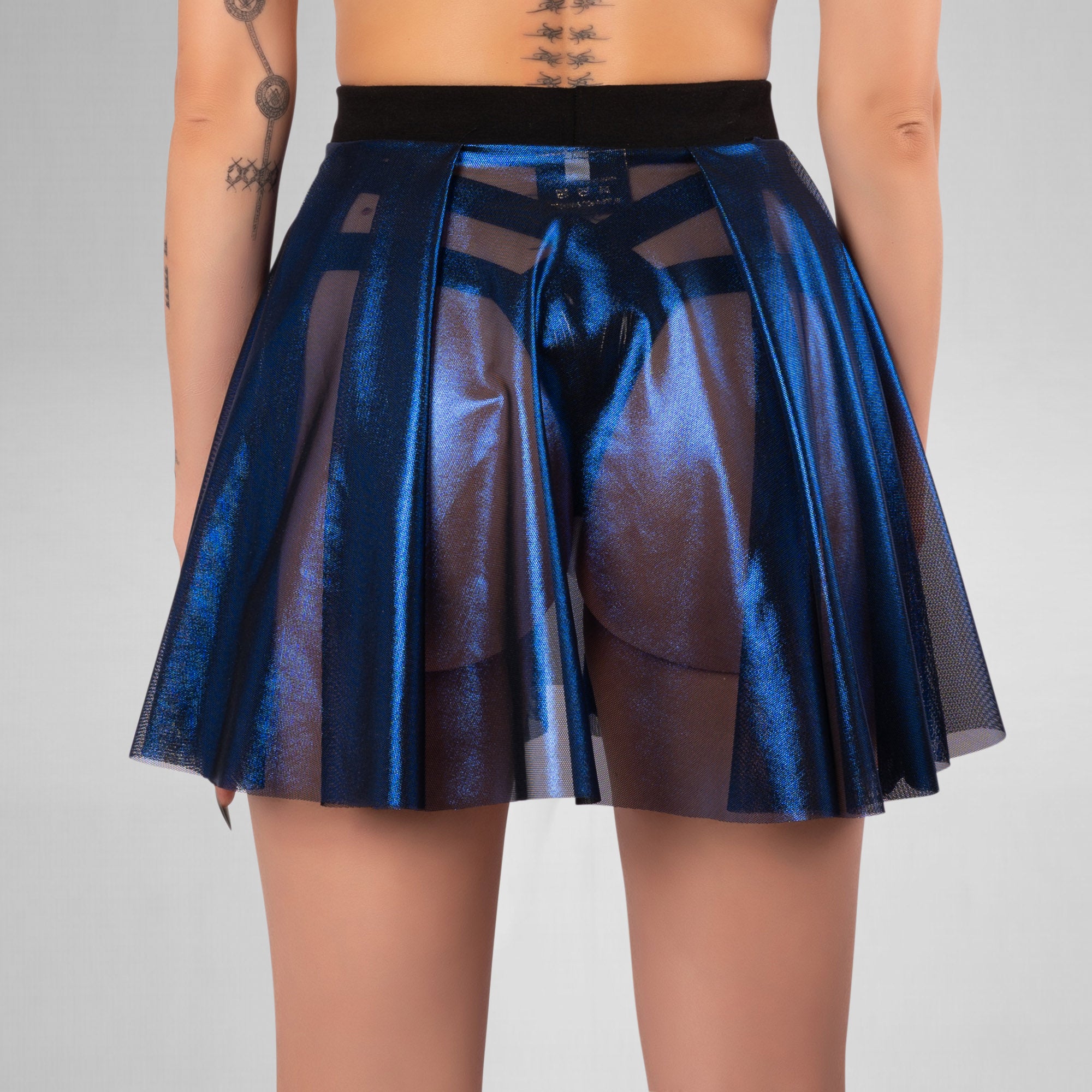 Blue metallic skirt worn by a person on a gray background