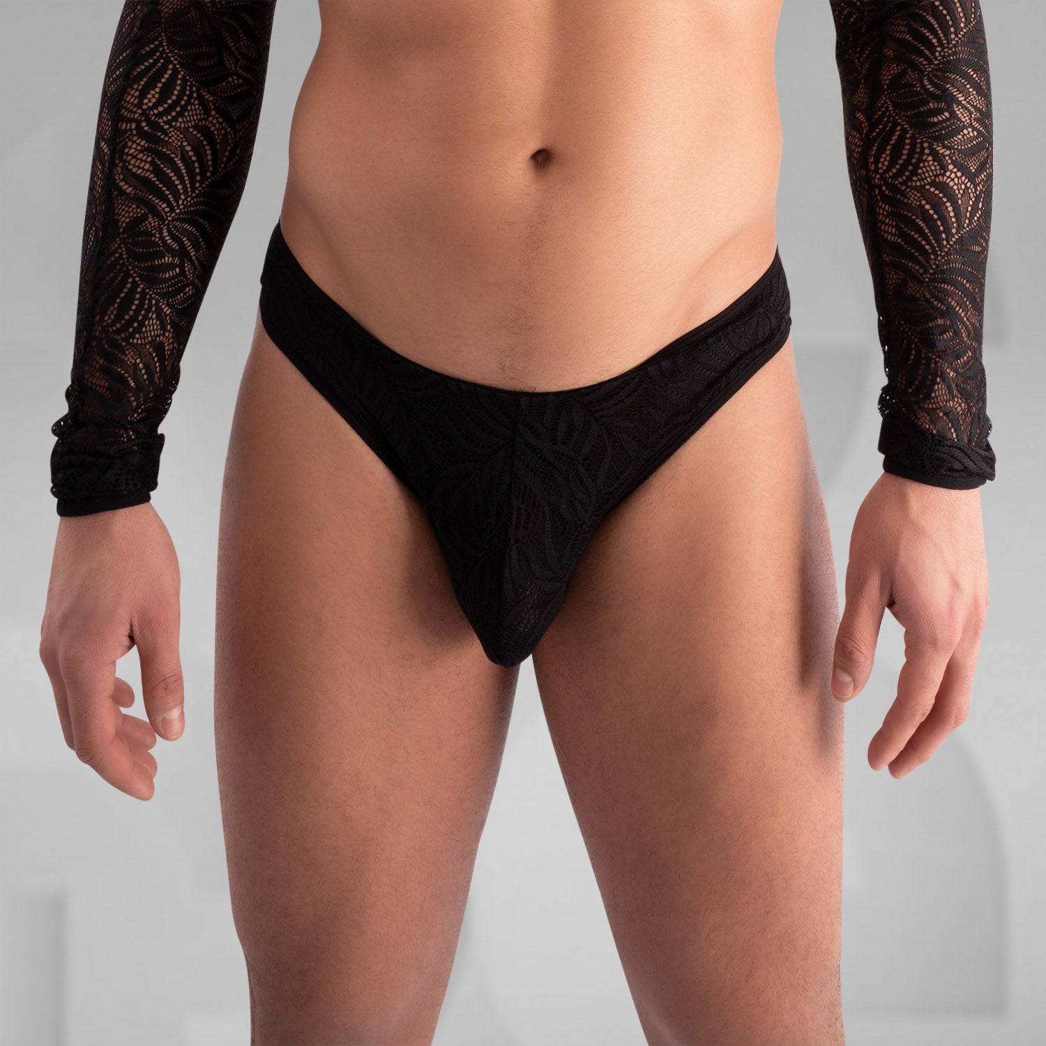 The back of the outfit features intricate lace detailing, enhancing the overall elegance of the design. The scalloped edges and lace-up closure add a playful yet refined touch, making it a perfect balance of allure and comfort. This piece beautifully showcases the body while providing a standout element for any daring ensemble.