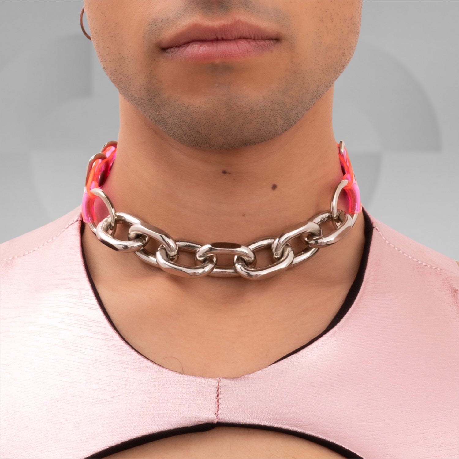 The Pink Chain PVC Choker from Broke Boutique is a striking accessory that combines bold metallic links with vibrant pink PVC accents. Designed to stand out, this choker adds a unique edge to any outfit, making it perfect for nightlife and clubwear. Its chunky design not only enhances your look but also embodies the playful, avant-garde spirit of contemporary fashion. Whether you're hitting a festival or a night out, this choker is an essential statement piece.