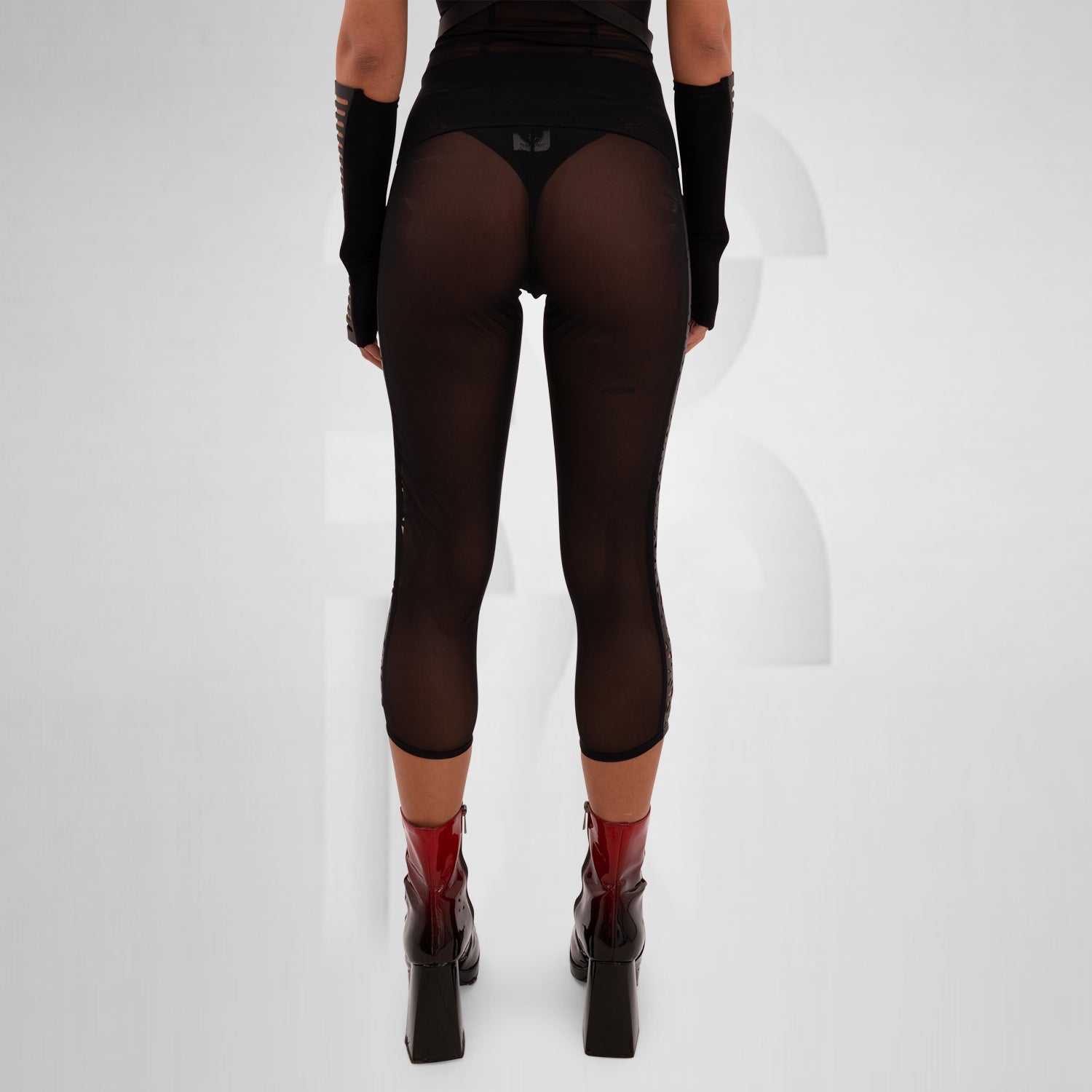 Sheer mesh leggings featuring a laser-cut panel with a psychedelic pattern, designed for bold self-expression and perfect for festivals, nightlife, and avant-garde outfits.