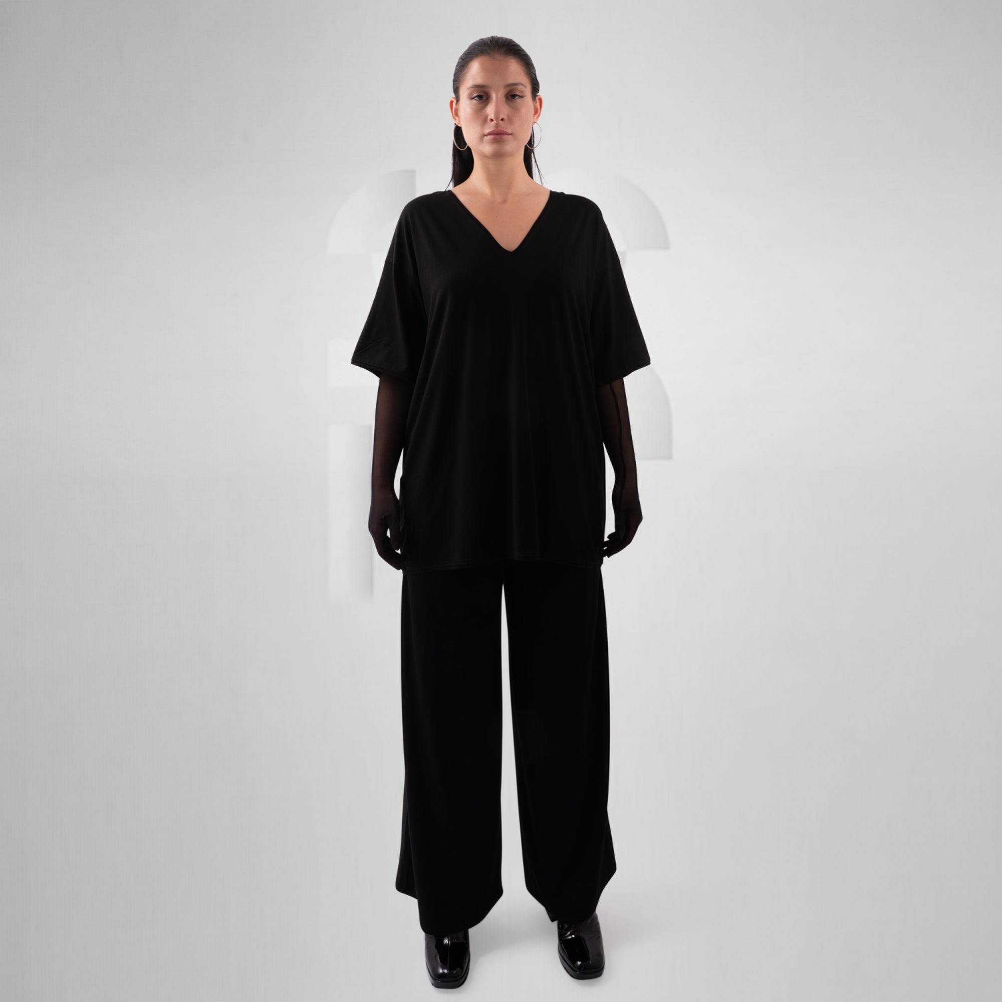 Person wearing a black outfit on a white background