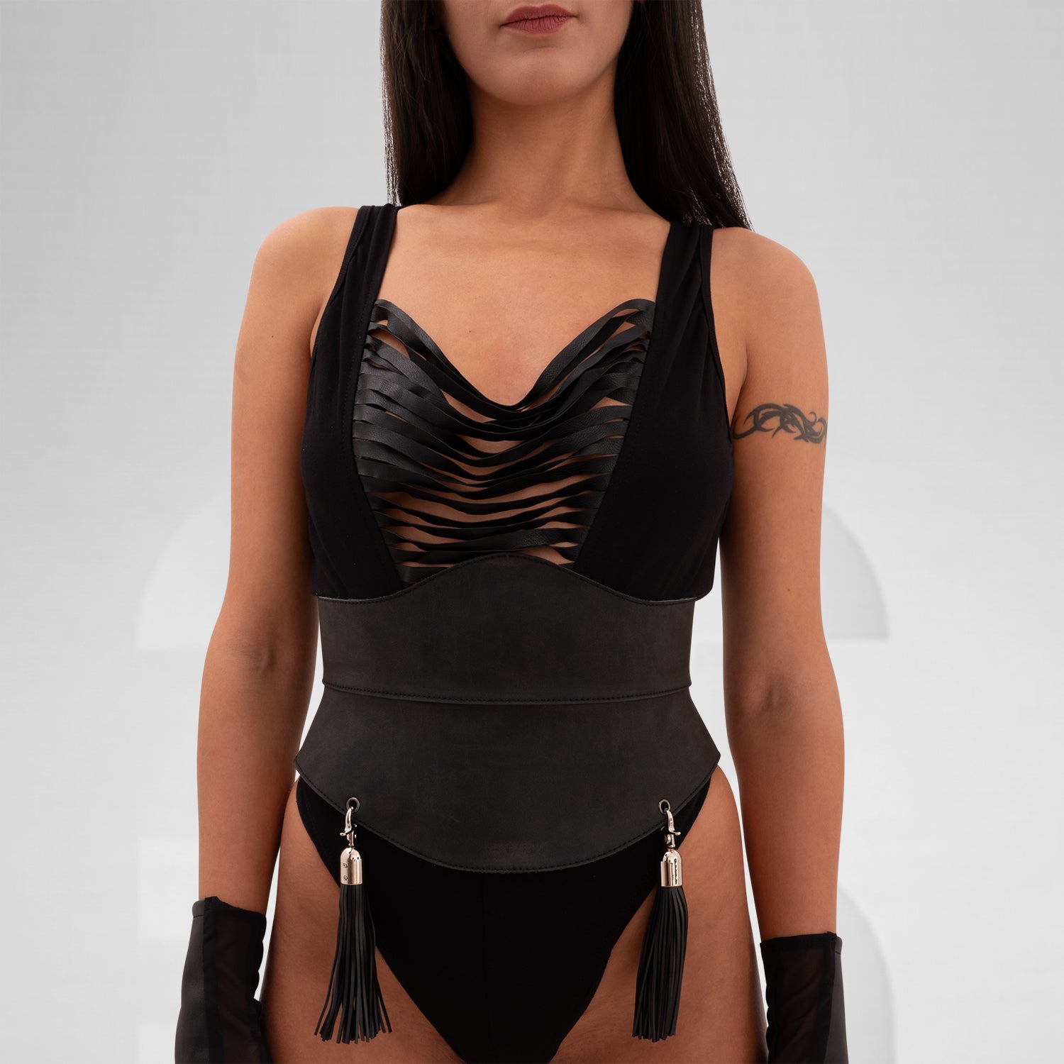 Elegant corset crafted from durable vegan leather, featuring adjustable lacing, detachable rubber tassels, and a structured yet comfortable fit, perfect for bold self-expression.