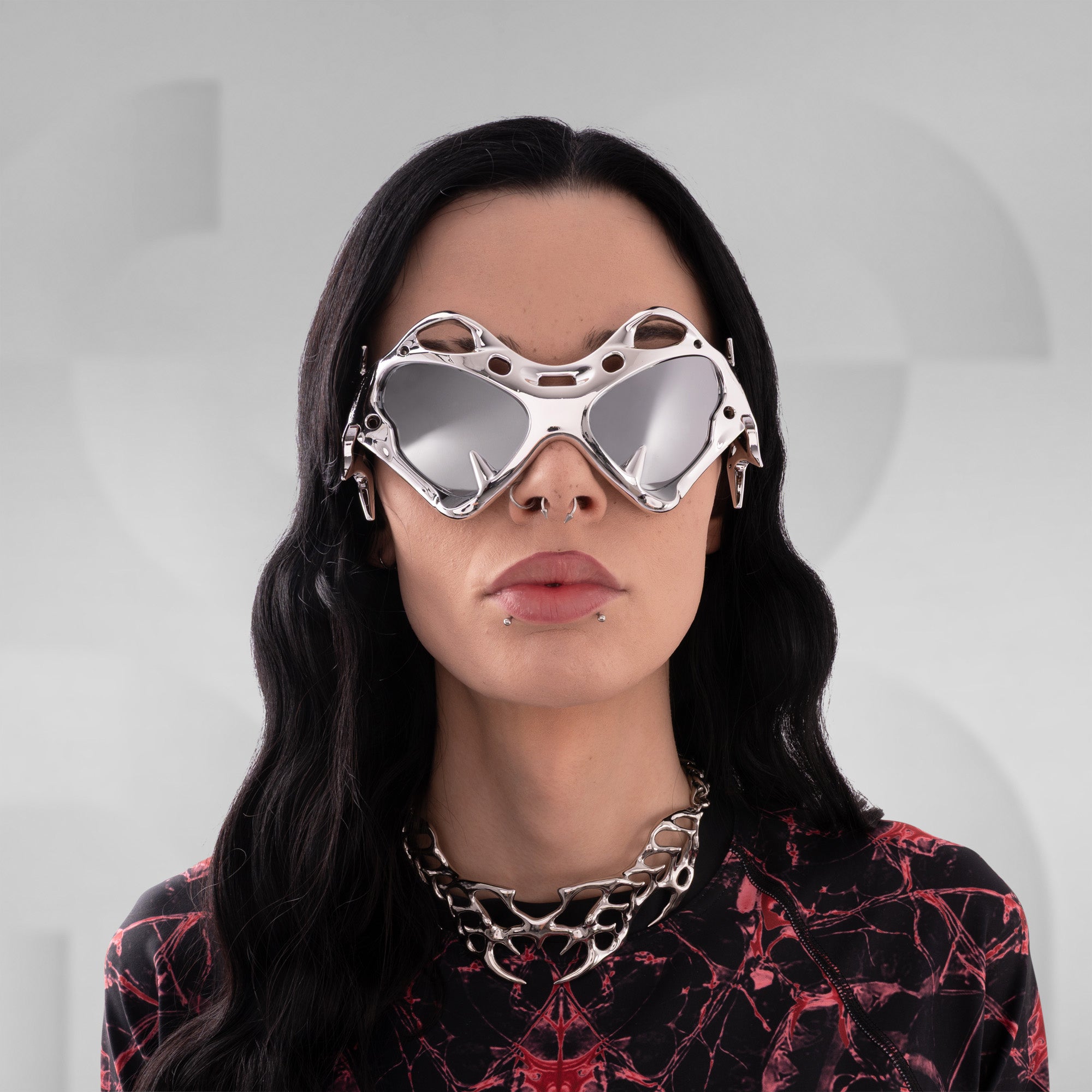 Person wearing futuristic goggles with a plain background