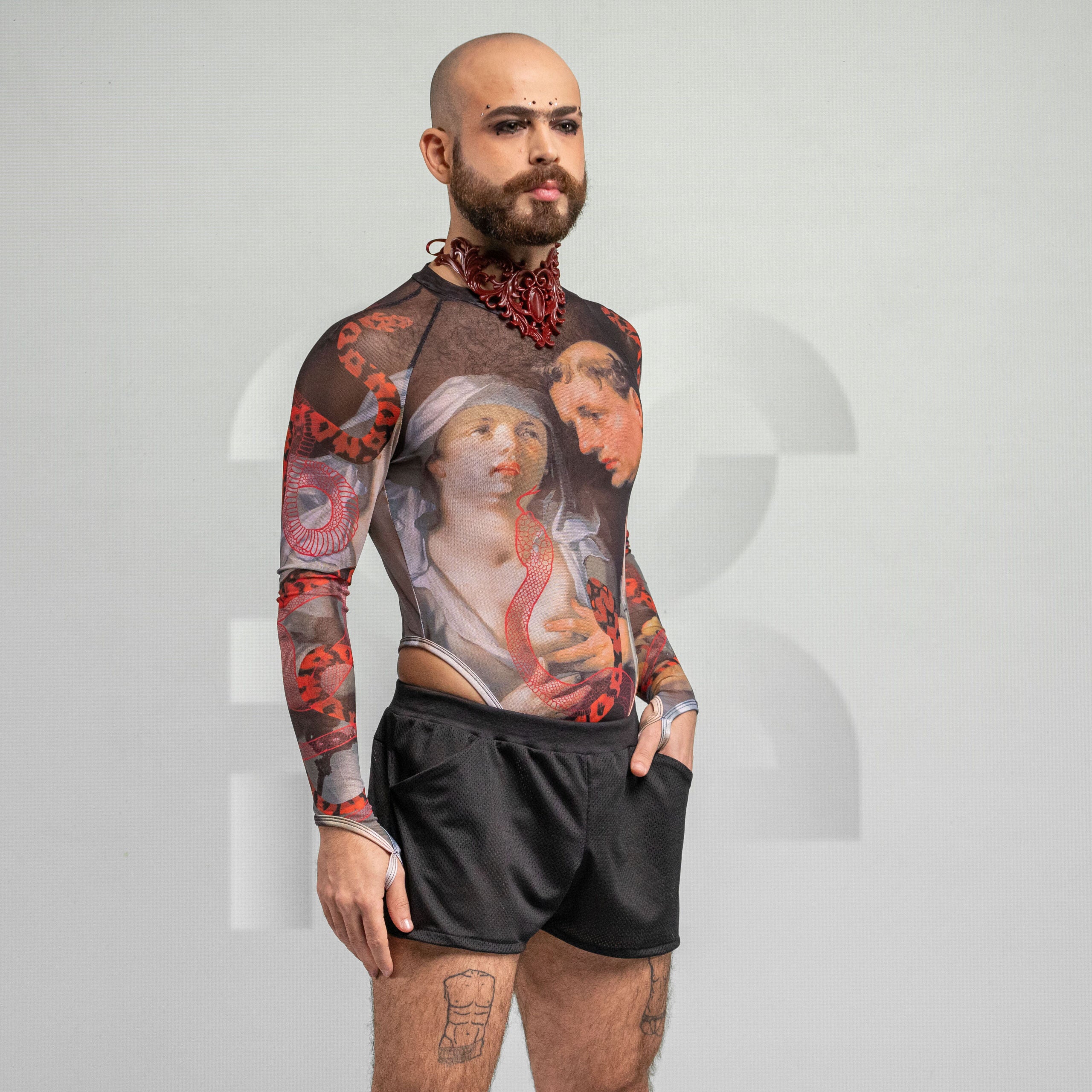 Side view of the artsy yet edgy Serpent Print Bodysuit with long sleeves and a thong by Effenberger Couture.