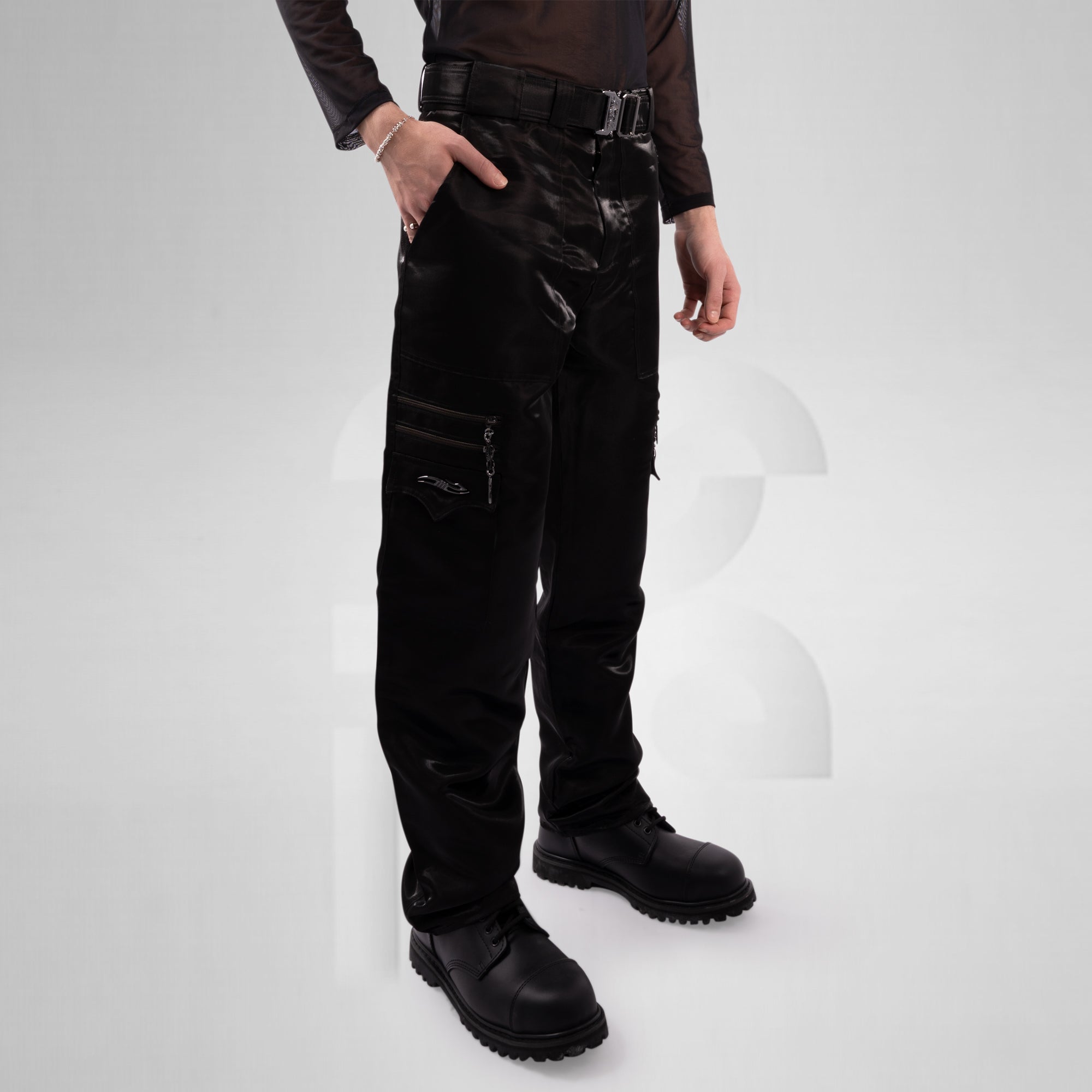 Person wearing black tactical pants on a white background