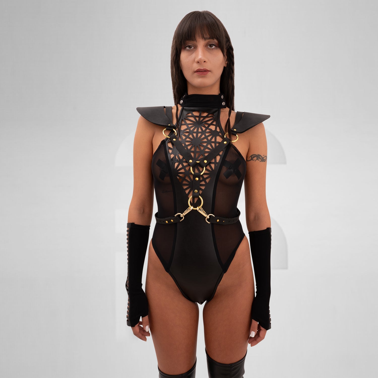 The Laser Cut Harness with Shoulder Details from designer Cyberesque is a daring fusion of avant-garde fashion and functionality. This eye-catching harness features intricate laser-cut designs that draw attention and elevate your outfit to new heights. With striking gold hardware and chic shoulder accents, it’s perfect for festivals, clubwear, and tribal gatherings. Designed for those who embrace their individuality and confidence, this piece transforms any ensemble into a bold statement that captures the e