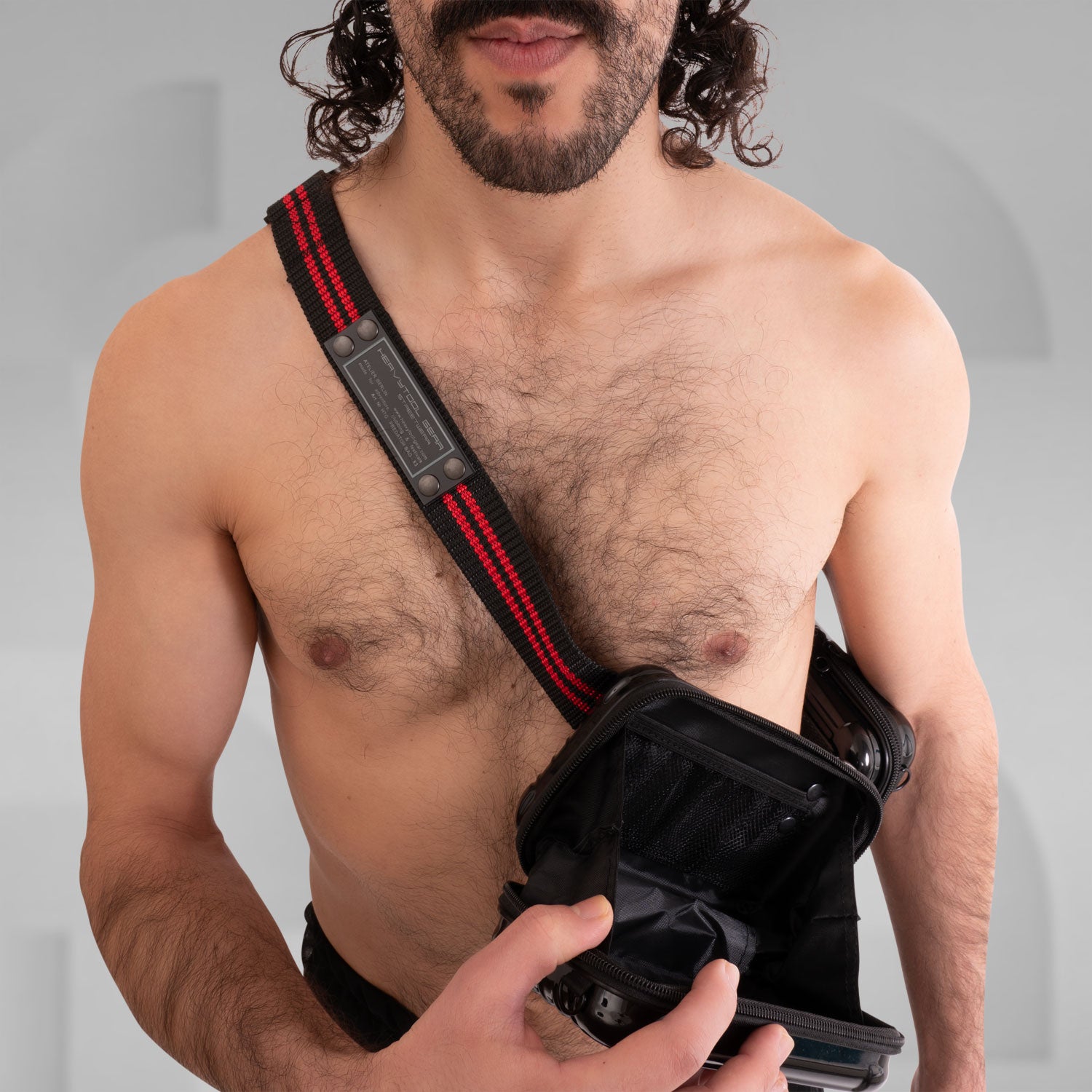 The image features a stylish Suitcase Crossbody Bag in a distinctive black design. This trendy bag is worn over the shoulder, offering a modern and functional look. Its sleek casing and practical compartments make it ideal for those who appreciate both fashion and utility while on the go.