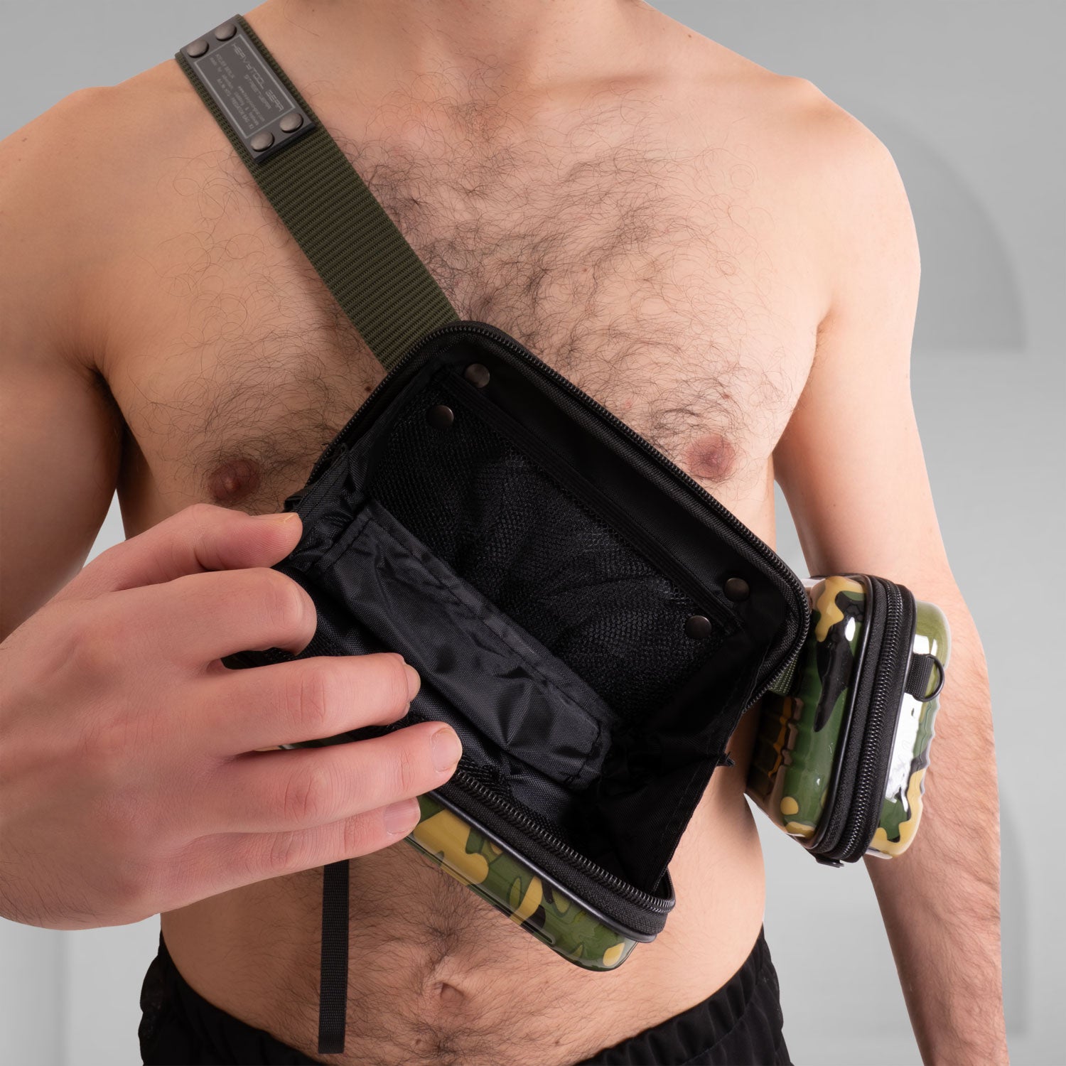 The image features a stylish Suitcase Crossbody Bag in a distinctive camouflage design. This trendy bag is worn over the shoulder, offering a modern and functional look. Its sleek casing and practical compartments make it ideal for those who appreciate both fashion and utility while on the go.