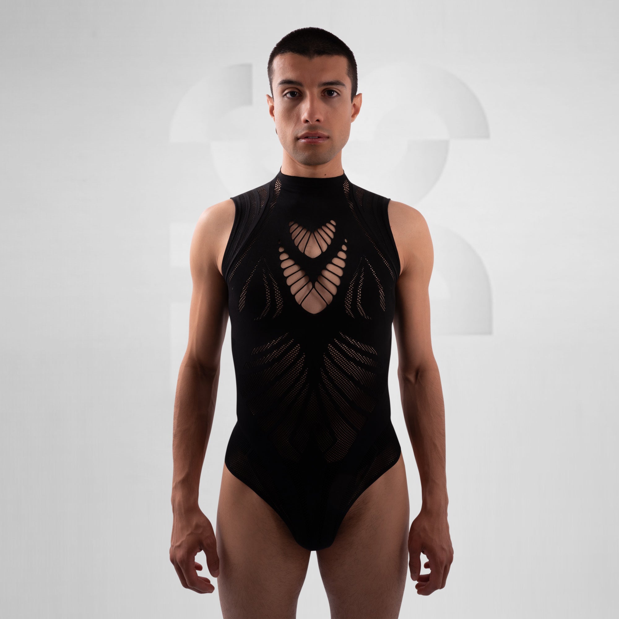 Man wearing a black sleeveless bodysuit with cut-out design on a white background