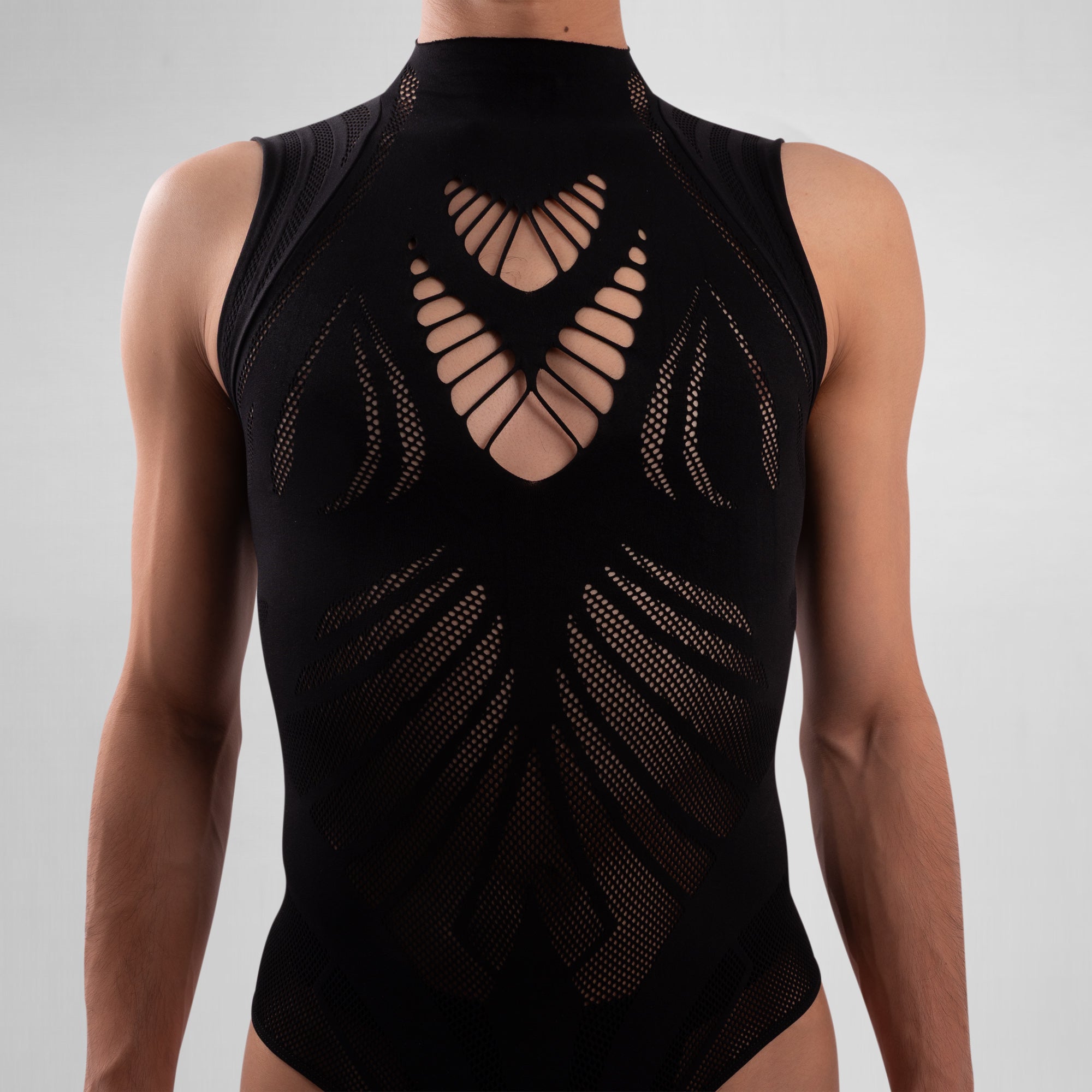 Black sleeveless top with geometric cut-out design on a gray background