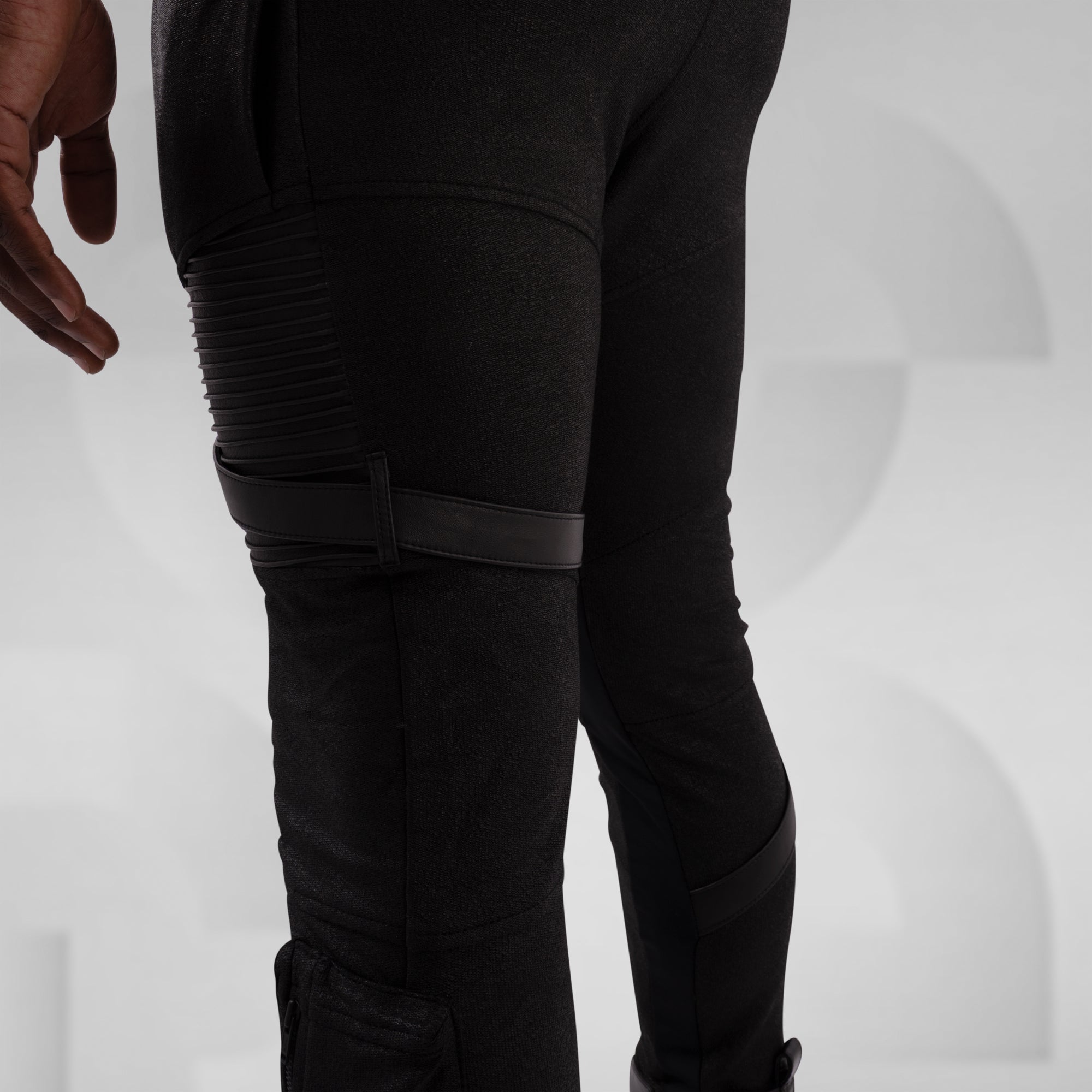 Black pants with textured design on a light gray background