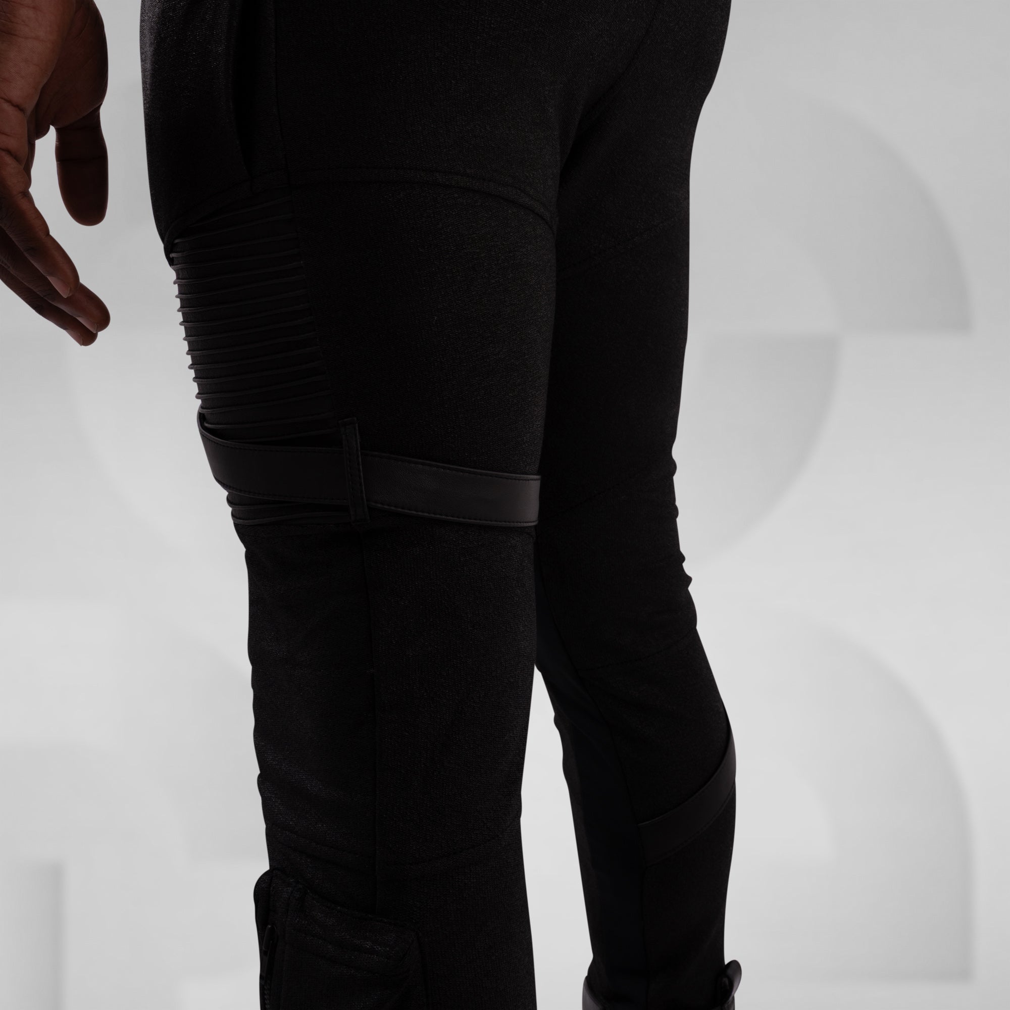 Black pants with textured design on a white background