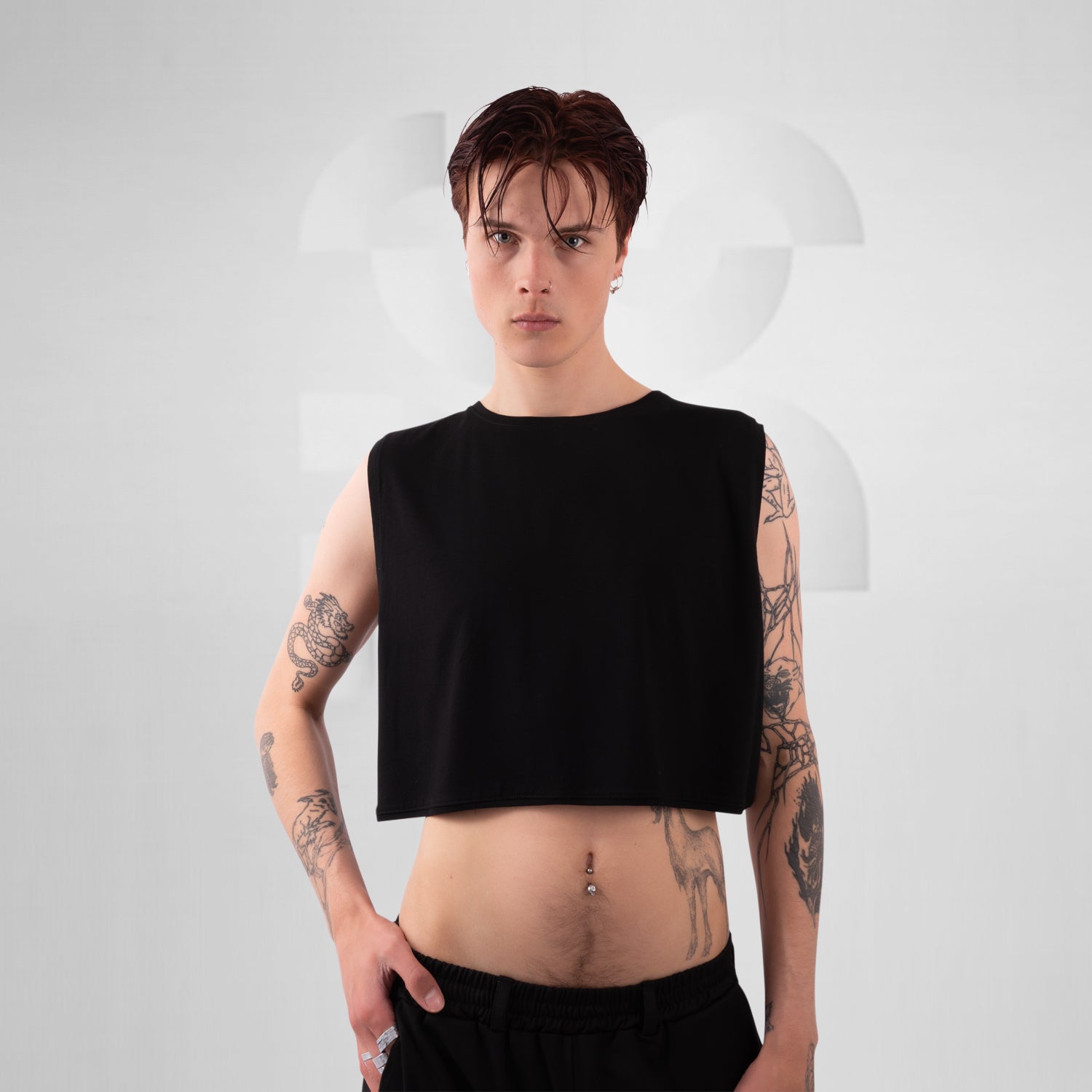 Person wearing a black sleeveless top against a white background