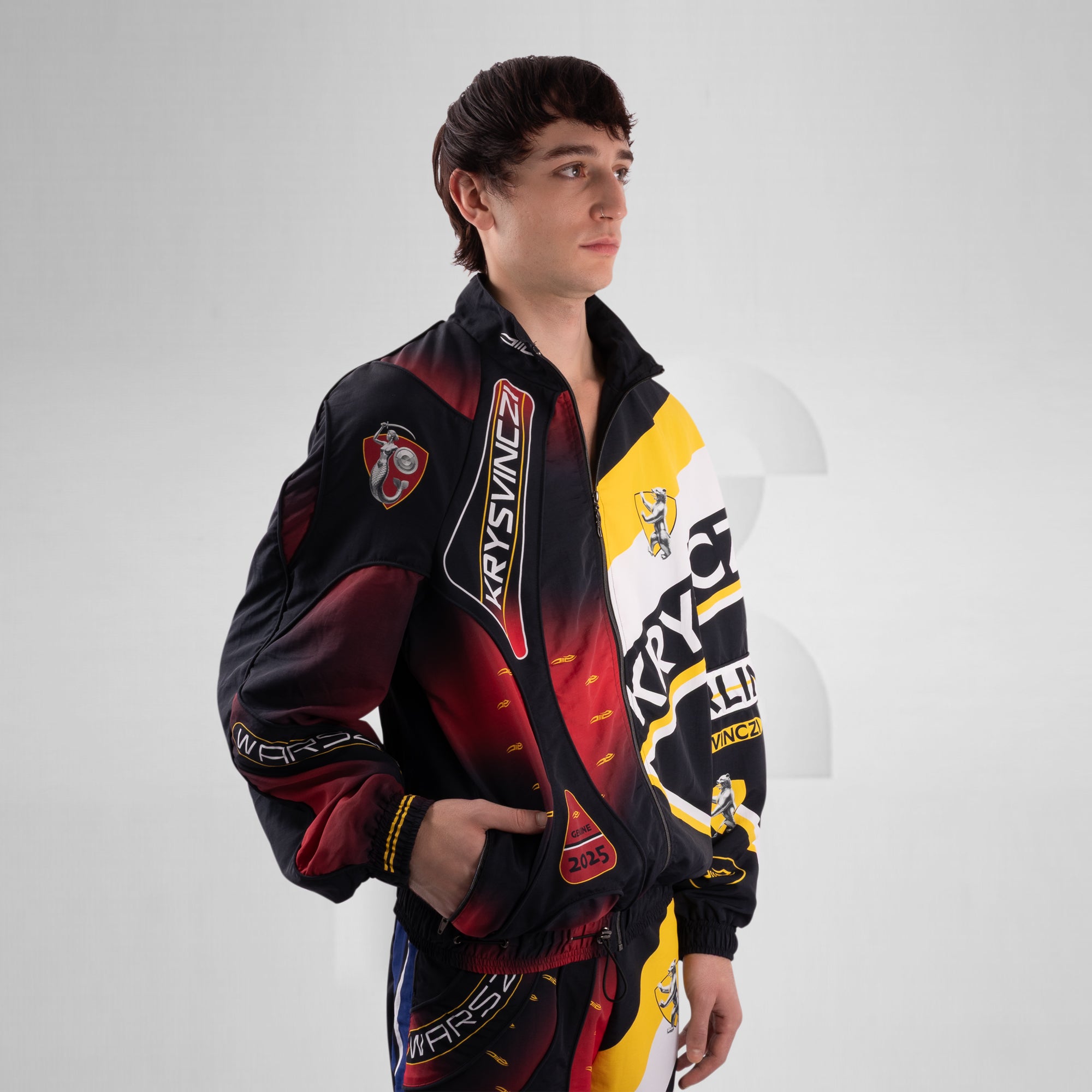 Person wearing a colorful jacket with branding on a white background