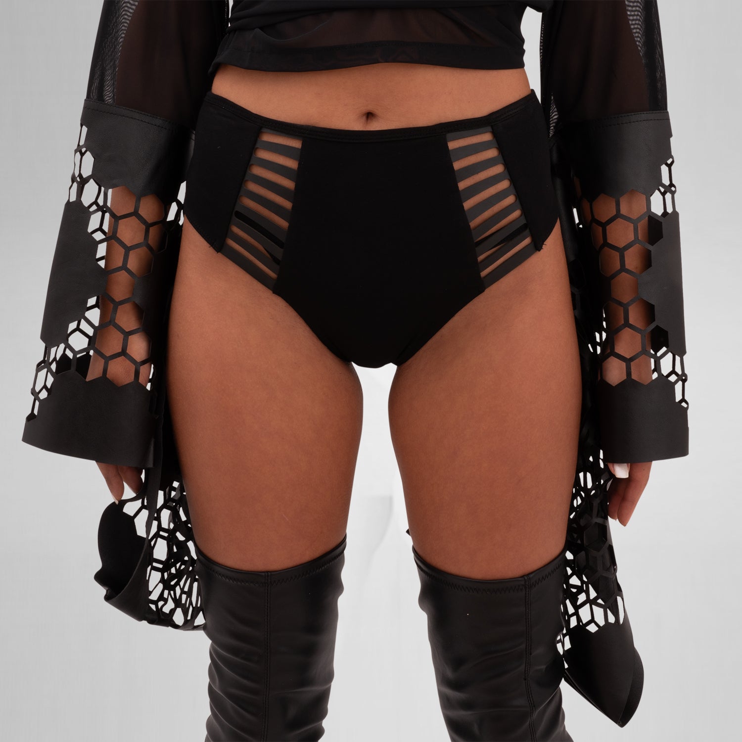 The Printed Sheer Kimono from Cyberesque is a stunning blend of elegance and edgy design. Featuring intricate laser-cut detailing on the sleeves and hem, this kimono adds a bold flair to any outfit. Crafted from lightweight, sheer fabric, it drapes beautifully, making it perfect for layering over clubwear or swimwear. Ideal for those who want to make a statement at festivals or embrace avant-garde fashion.