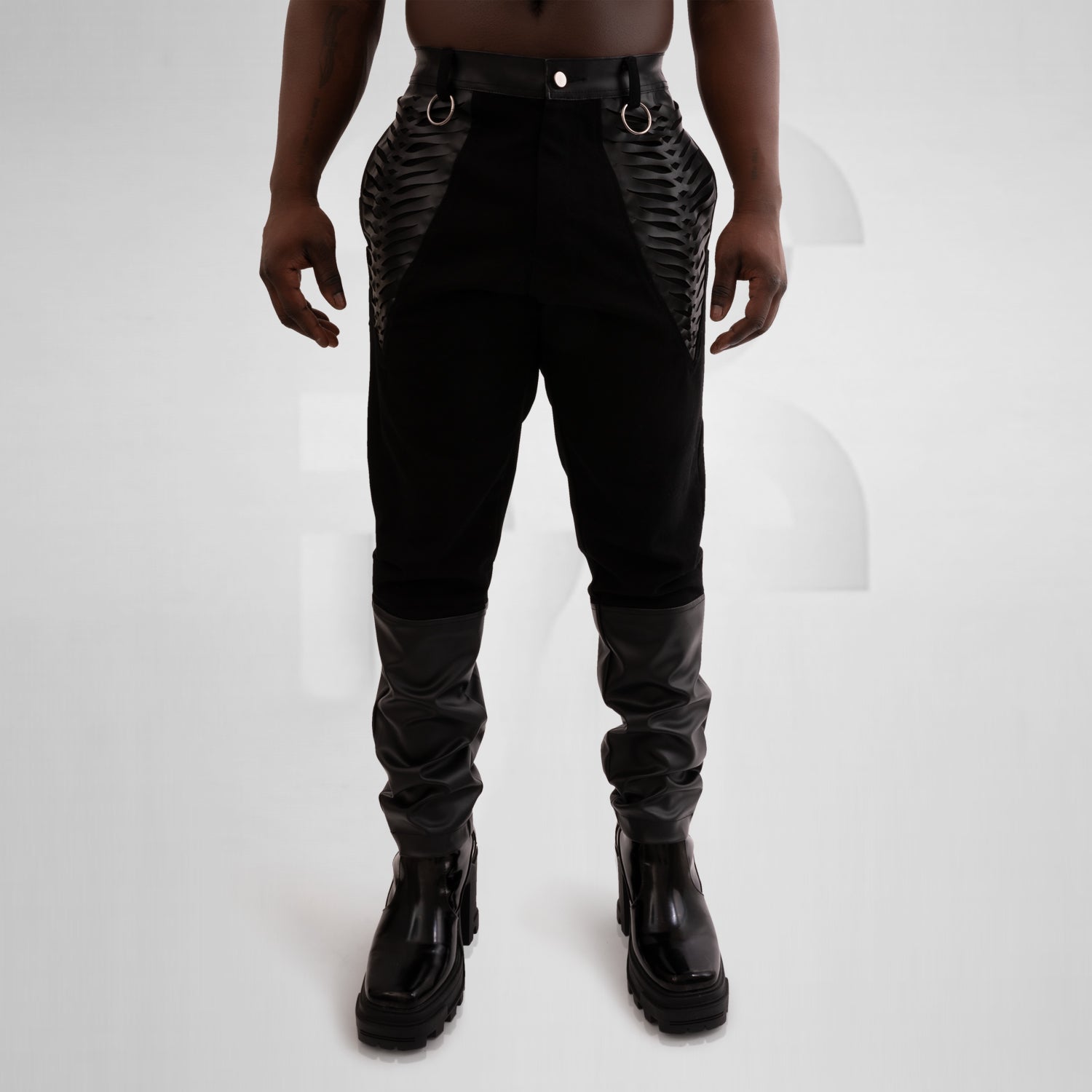 Black jeans with intricate faux leather laser cut pockets and accents for a trendy and edgy look