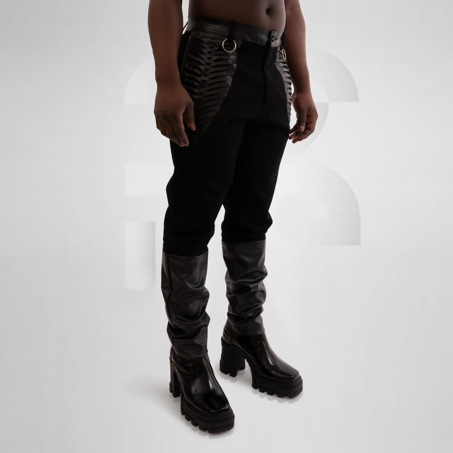 Black jeans with intricate faux leather laser cut pockets and accents for a trendy and edgy look