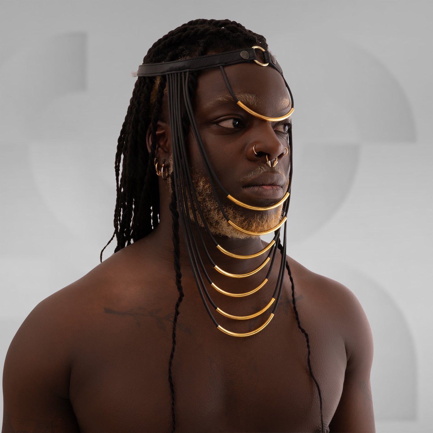 This eccentric headpiece is crafted from faux leather and designed to make a futuristic statement infused with ancient spirit.