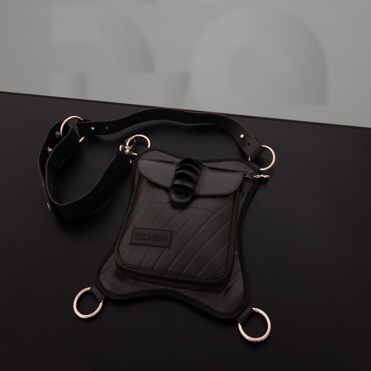 Faux leather hip bag featuring silver ring details, waterproof zipper, and sustainable materials. Perfect for festivals, nightlife, and bold fashion statements.