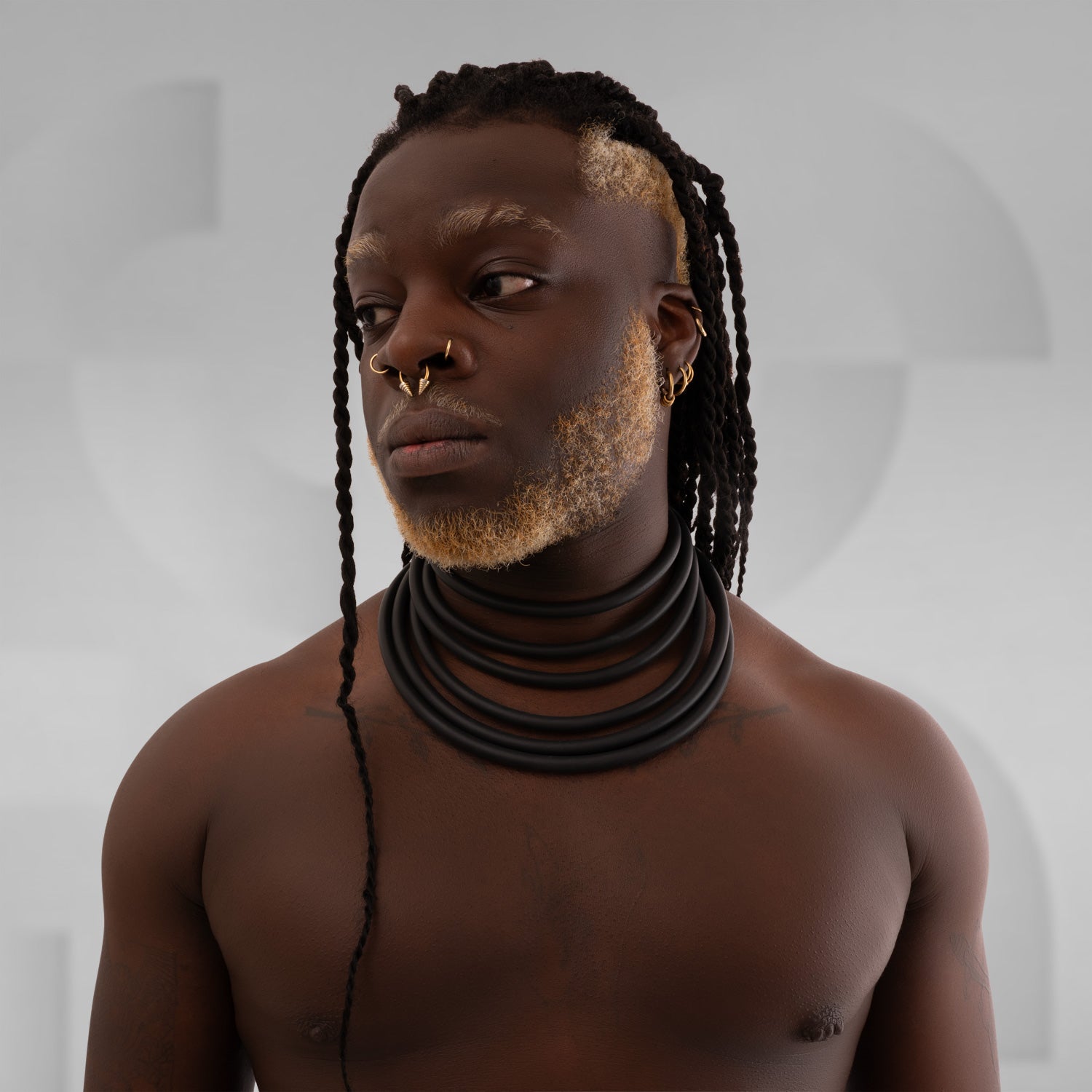 Tribal black collar made out of rubber tubes, bringing back that ancestral vibe.