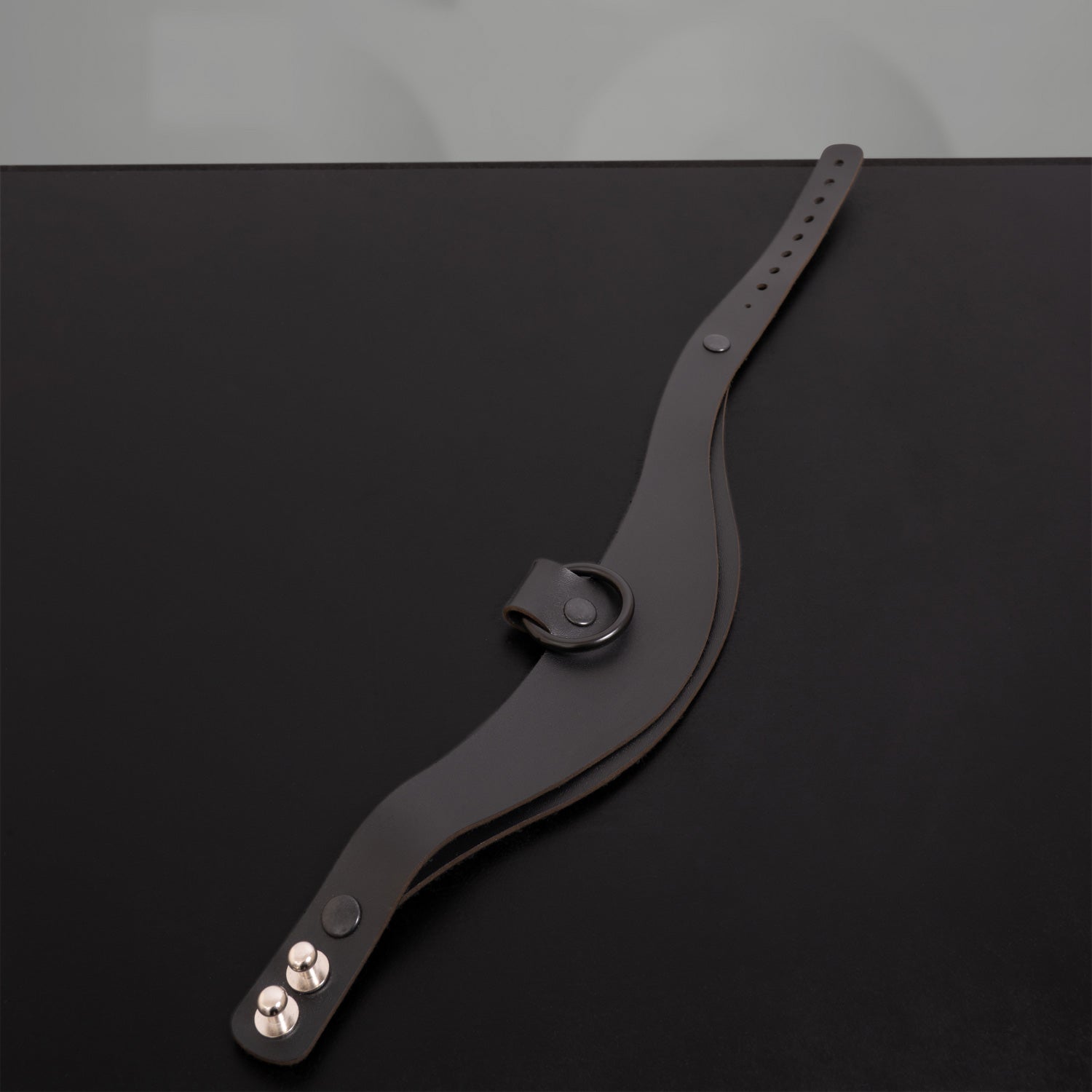 A sleek, bold accessory crafted from eco-conscious materials, perfect for avant-garde fashion and nightlife.