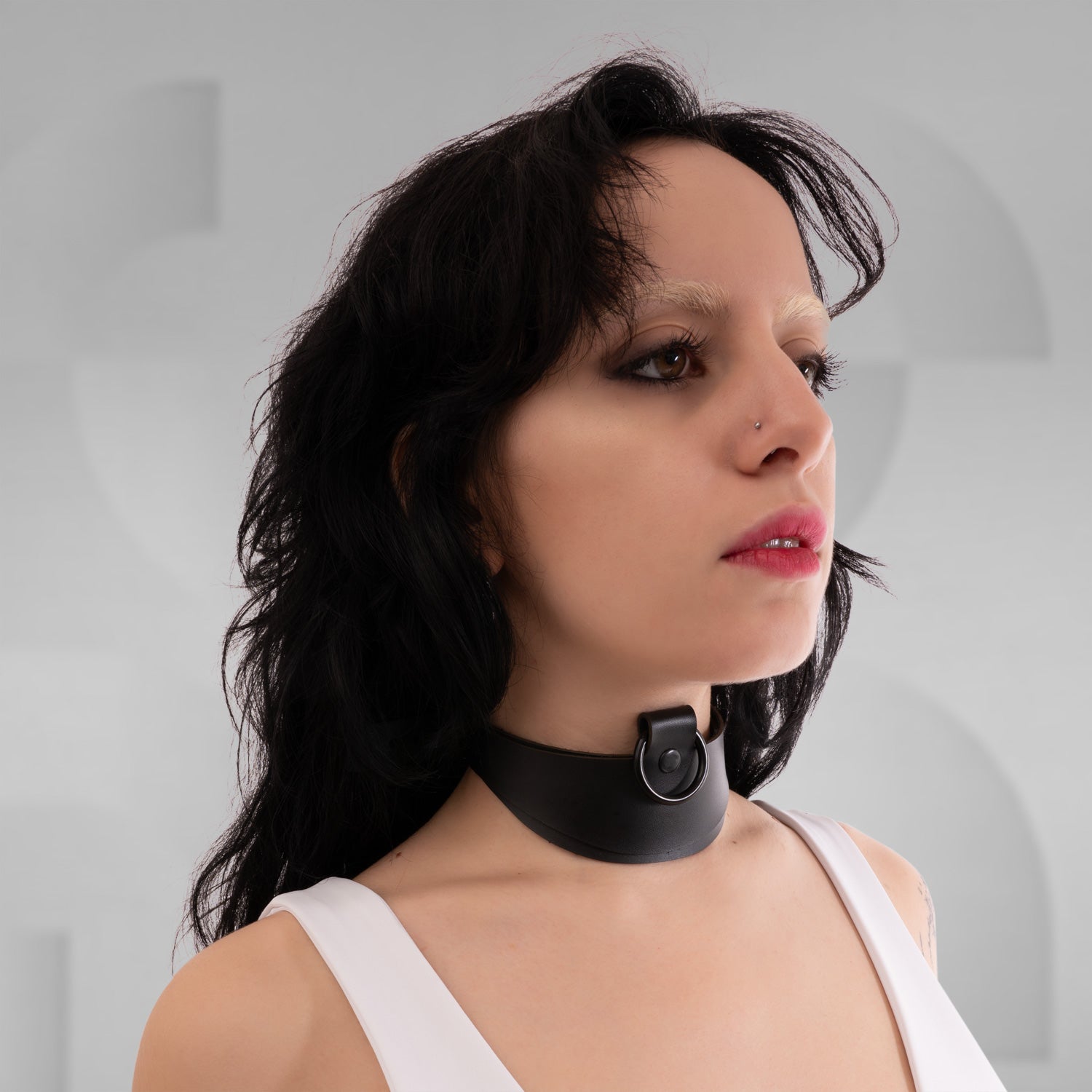 A sleek, bold accessory crafted from eco-conscious materials, perfect for avant-garde fashion and nightlife.