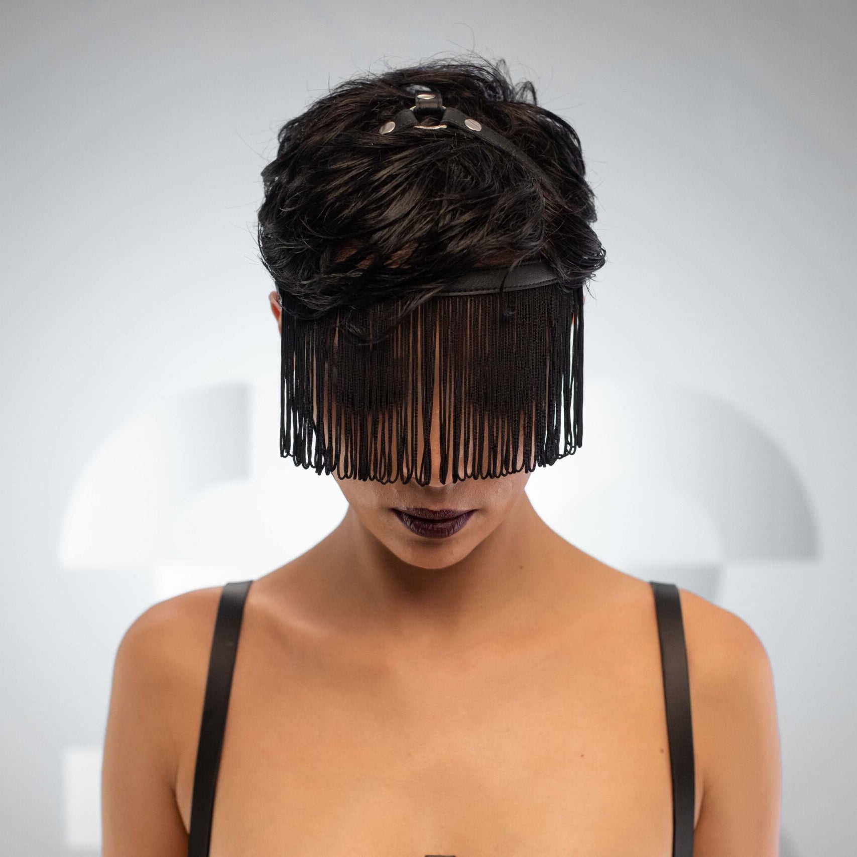 The faux leather fringe head harness, crafted for those who dare to defy the ordinary and embrace their unapologetic power.