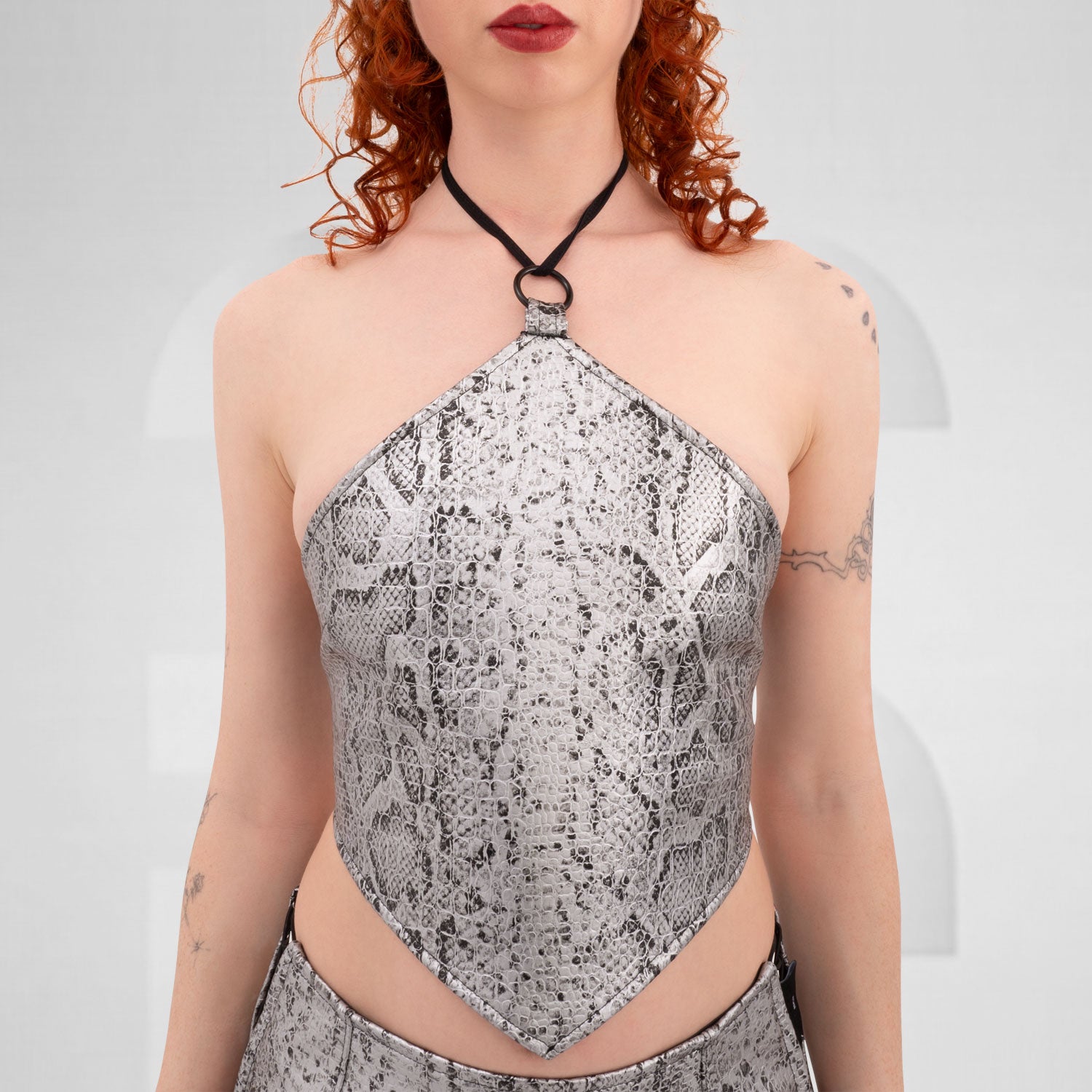 Stylish silver PVC snake skin rombo top featuring a lace tightening detail at the back.