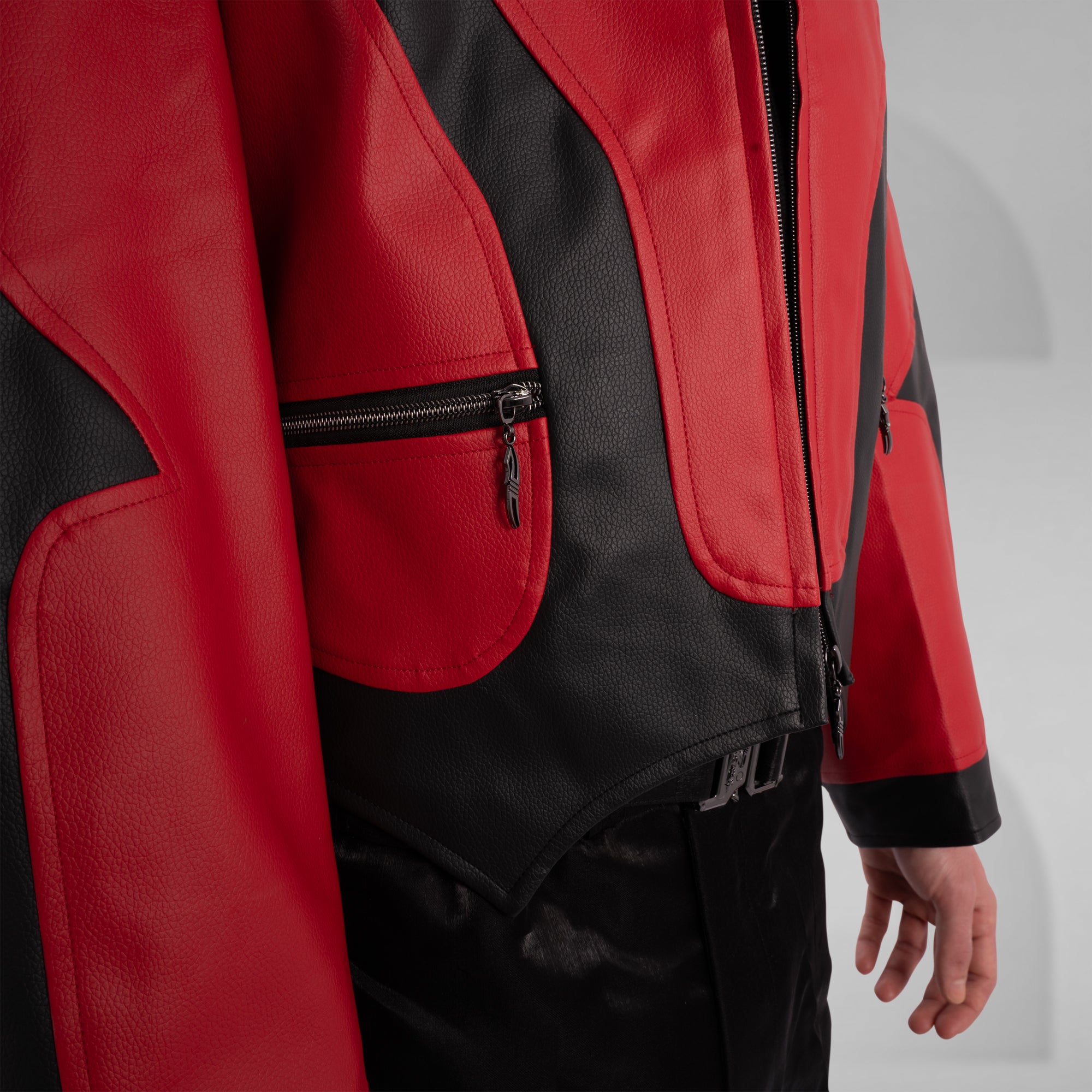 Red and black jacket with a zipper pocket on a gray background