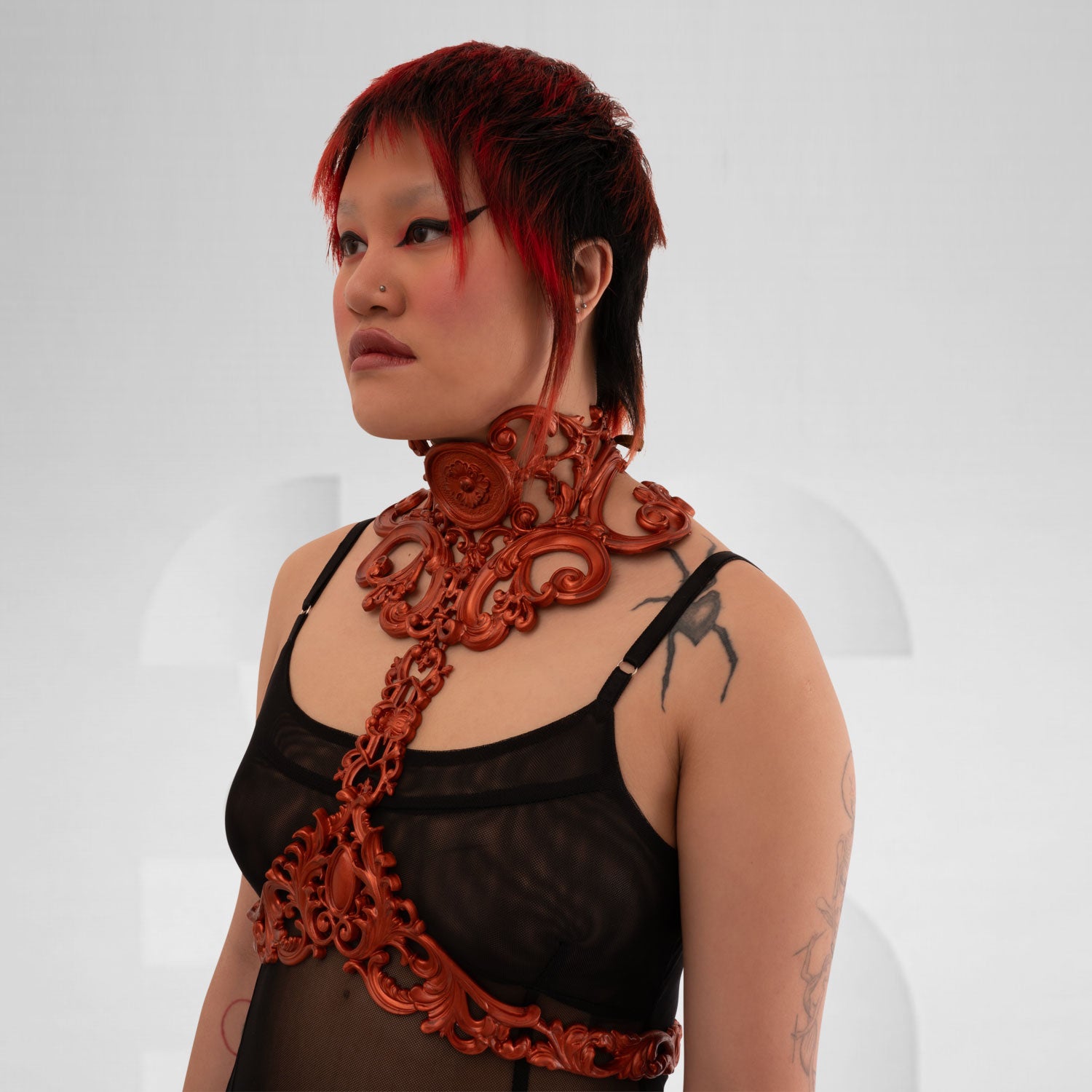 This image features a model wearing a stunning copper-colored harness with intricate baroque detailing. The harness elegantly frames the model's figure, combining artistic elements with a contemporary edge. Its bold design makes it an exceptional statement piece, ideal for avant-garde fashion enthusiasts. Perfect for nightlife or enhancing casual outfits, this harness exudes confidence and style.