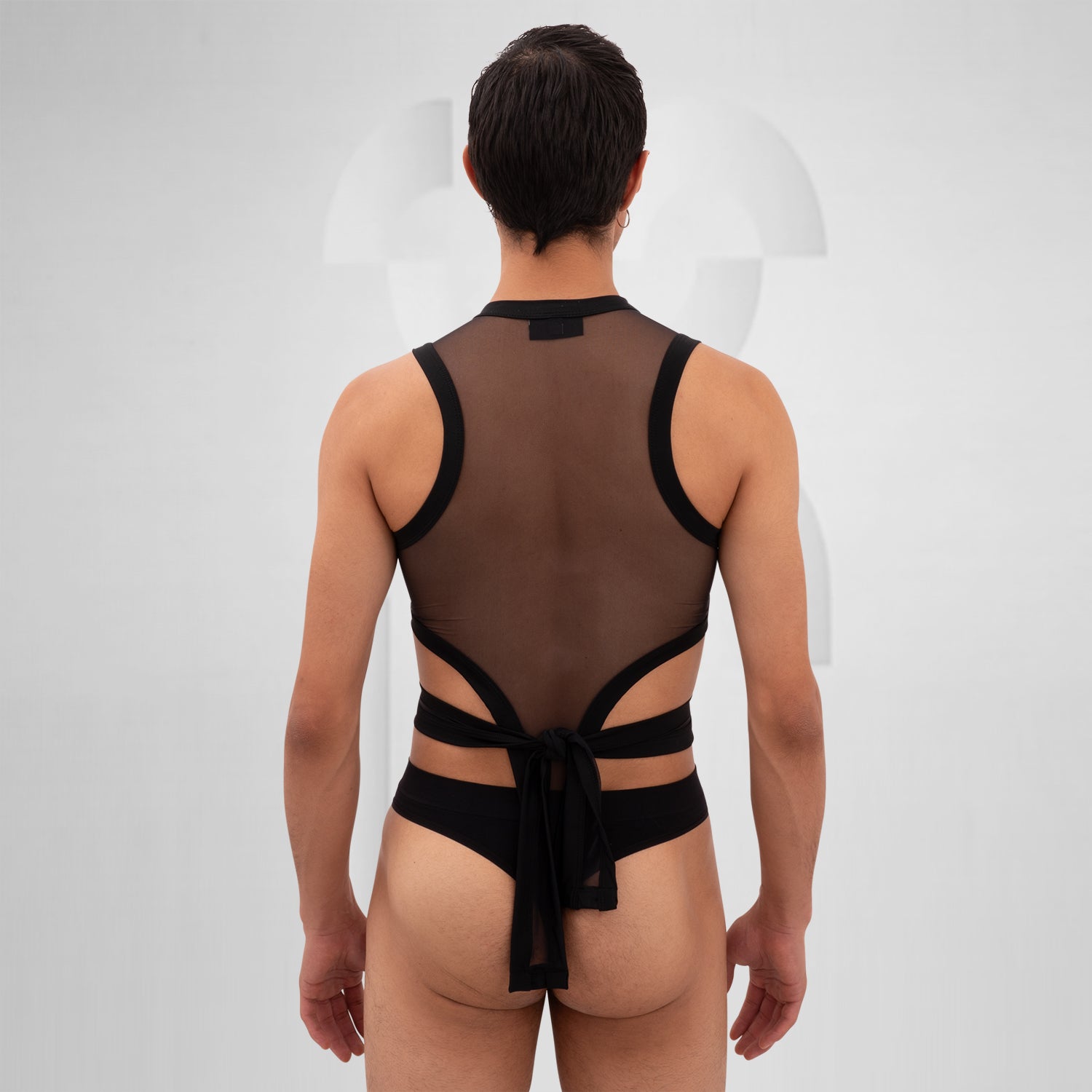 The Bound Gender-Neutral Meshed Bodysuit from Berlin designer Nur Hektor is a striking blend of edgy aesthetics and avant-garde fashion. Featuring sheer mesh and bold cut-out details, this unique piece embraces a daring silhouette perfect for festivals and clubwear. The innovative wraparound design not only highlights your figure but also allows for expressive individuality. 