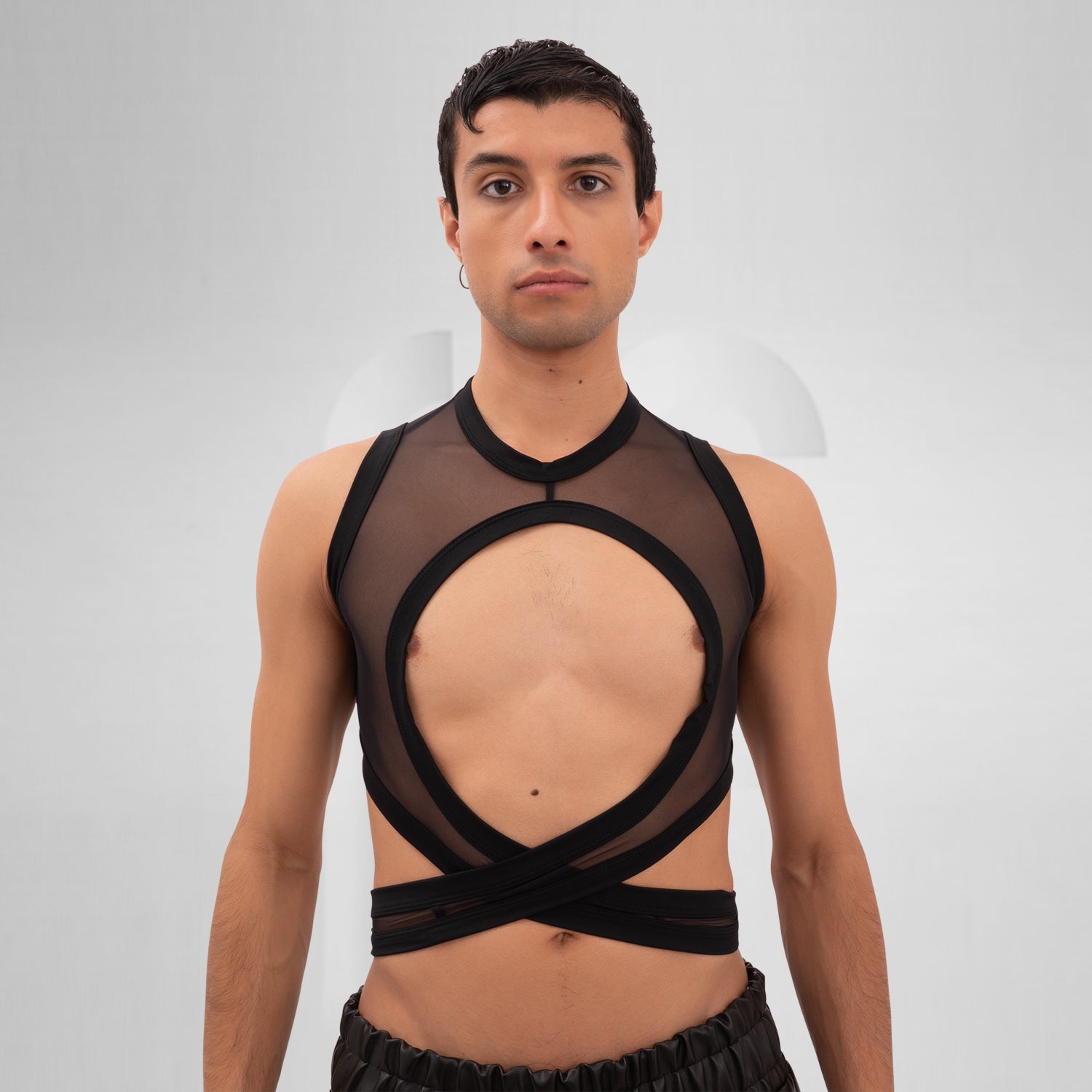 Introducing the Bound Gender-Neutral Mesh Top from Berlin designer Nur Hektor. This avant-garde piece combines sheer mesh with a daring wraparound design, making it perfect for festivals and clubwear. The striking cut-out detail offers a bold yet stylish silhouette, allowing for expressive individuality and a unique fashion statement.