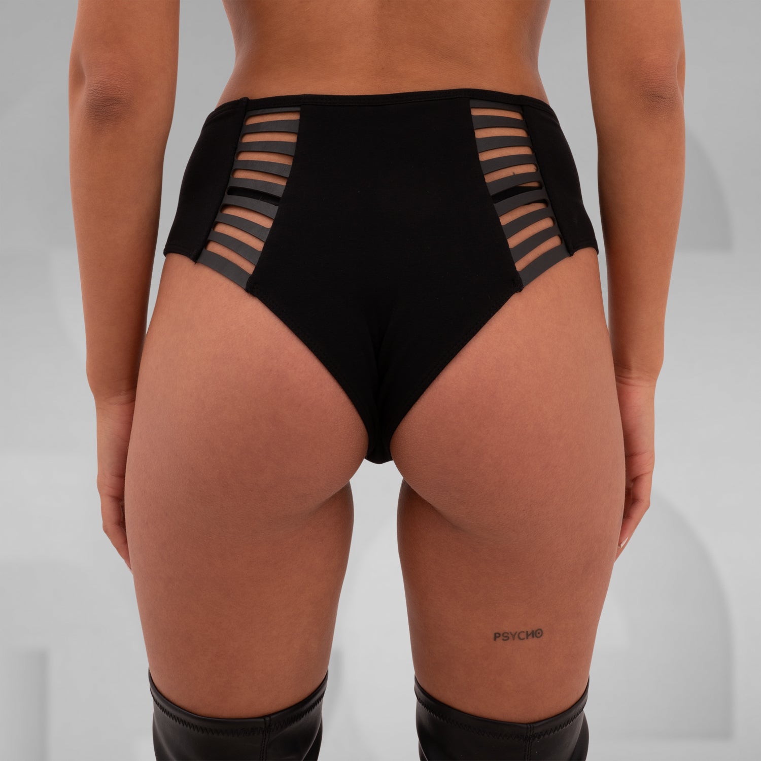 These High-Waisted Strappy Briefs from Cyberesque blend bold design with comfort and style. Featuring sleek strappy details on the sides, they add an edgy touch to your wardrobe. Perfect for pairing with your favorite festival or clubwear pieces, these briefs offer a seamless fit that embraces your curves. Ideal for those who love to make a statement, they bring a modern, avant-garde flair to any ensemble.