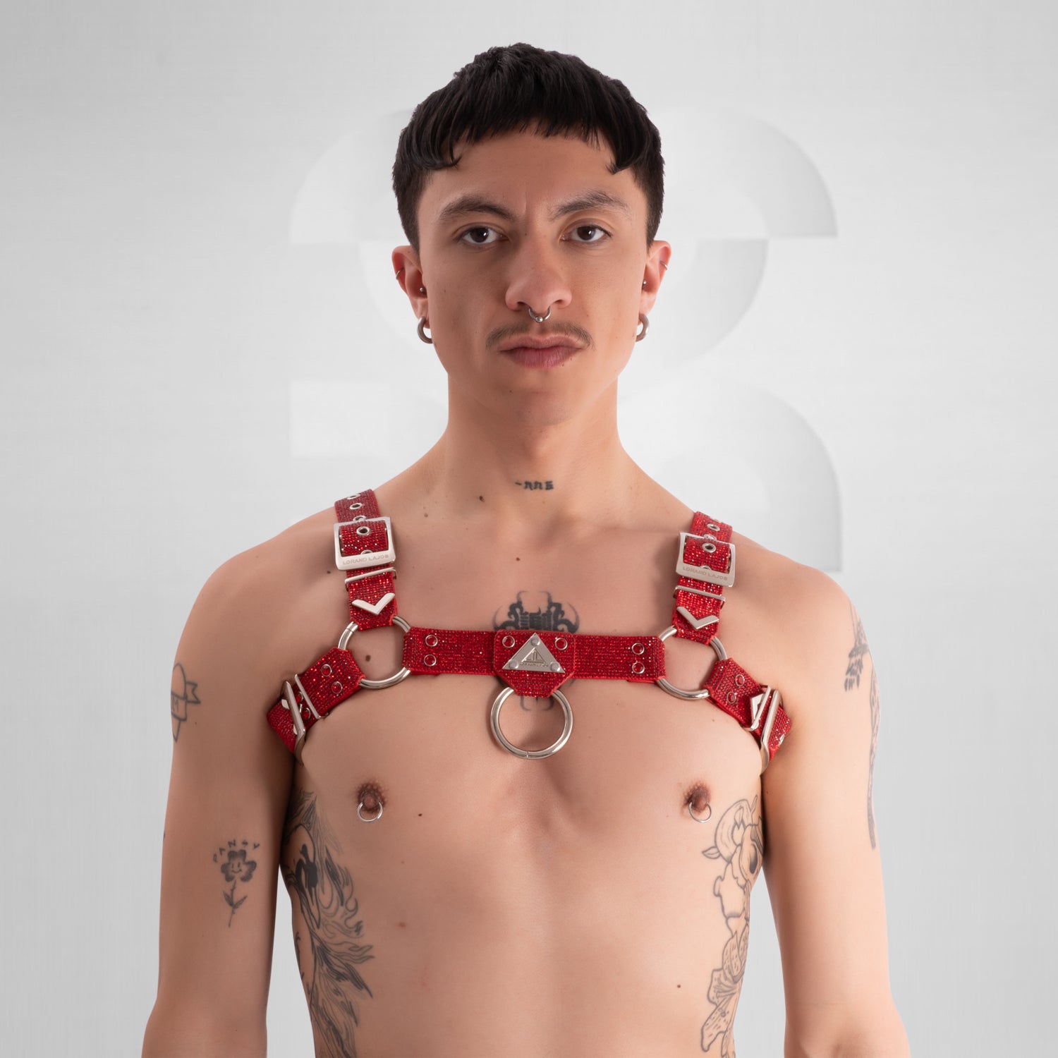 Man wearing a red harness on a white background