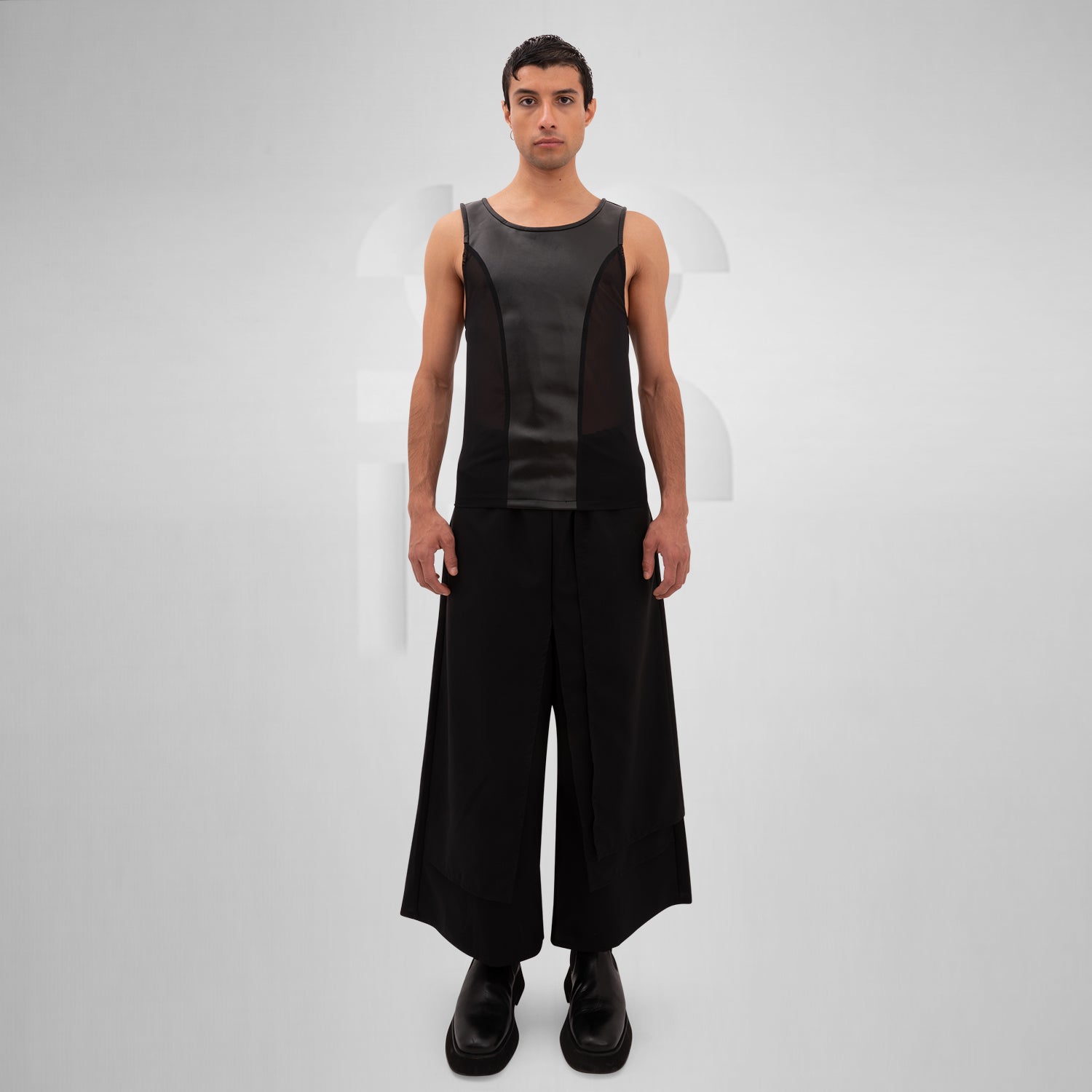 The Cutting Edge Vegan Leather Mesh Tanktop from Cyberesque showcases a sleek and innovative design. With a fusion of vegan leather and mesh details, this tank top highlights a modern, avant-garde silhouette. Perfect for tribal festivals or bold street style, it embodies both sophistication and edgy flair. Pair it with wide-legged trousers for a striking, fashion-forward ensemble that stands out in any setting.