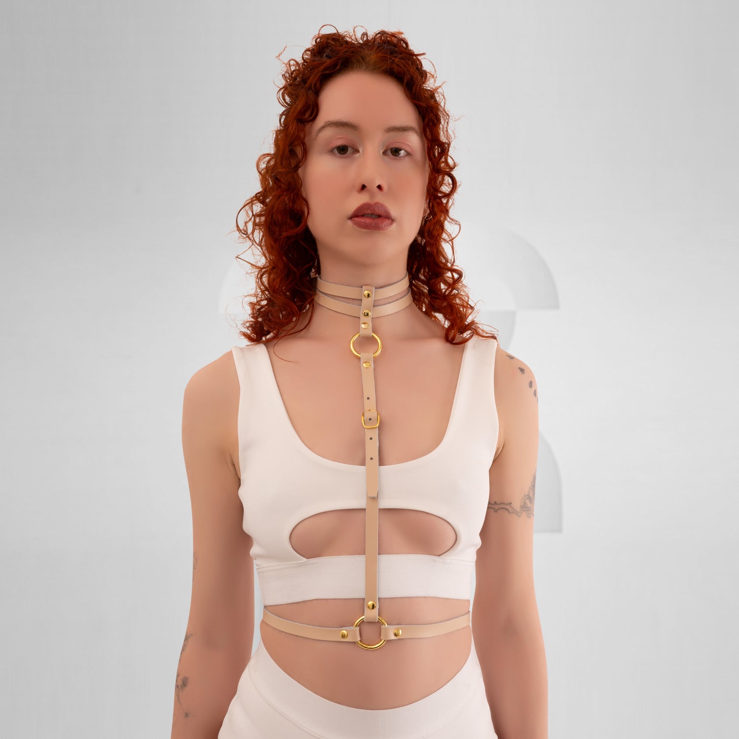 The Delicate Waist Harness in Nude Leather from Miss Overdose, crafted from real leather, elegantly displayed against a neutral background. This filigree design showcases its subtle sophistication, perfect for enhancing any outfit for various occasions, including techno clubs, festivals, and casual outings.