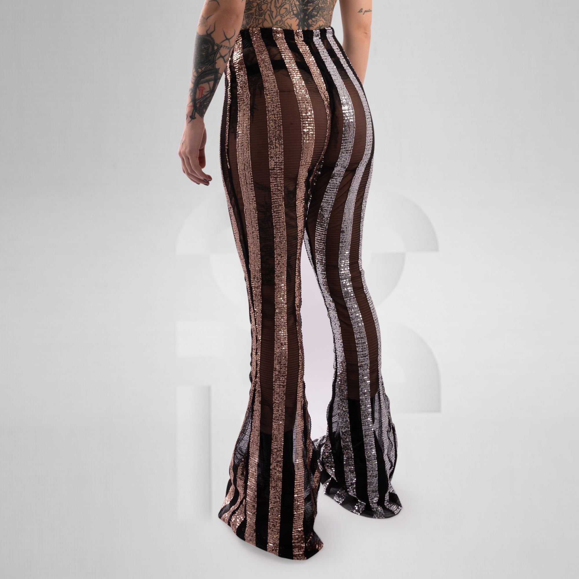 Striped pants with brown and silver pattern on a white background