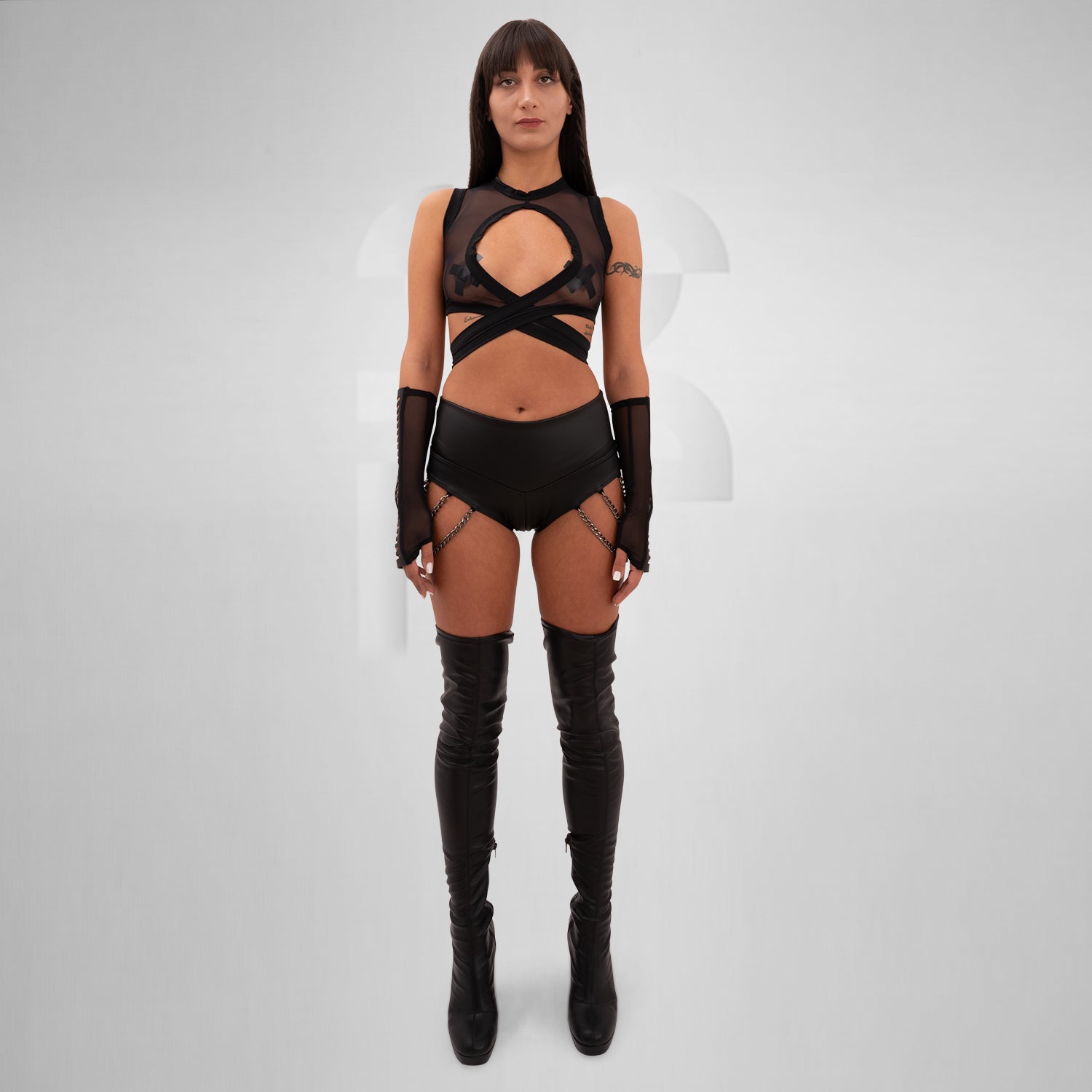 The Vegan Leather Chain-Detail Hotpants from Cyberesque are the ultimate blend of boldness and sophistication. Designed for the fashion-forward individual, these hotpants feature sleek vegan leather construction complemented by striking chain details that add an edgy flair. Perfect for festivals, club nights, or tribal gatherings, they seamlessly combine comfort with avant-garde style. 