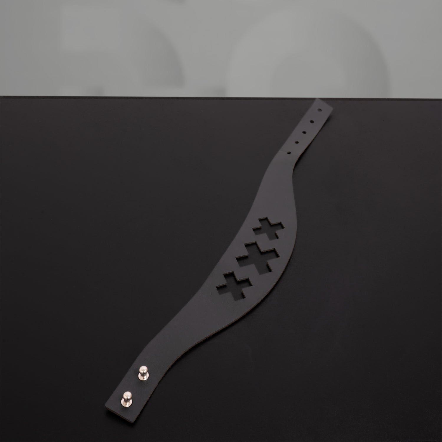 Intricate triple-X laser-cut choker for a distinctive, modern aesthetic.