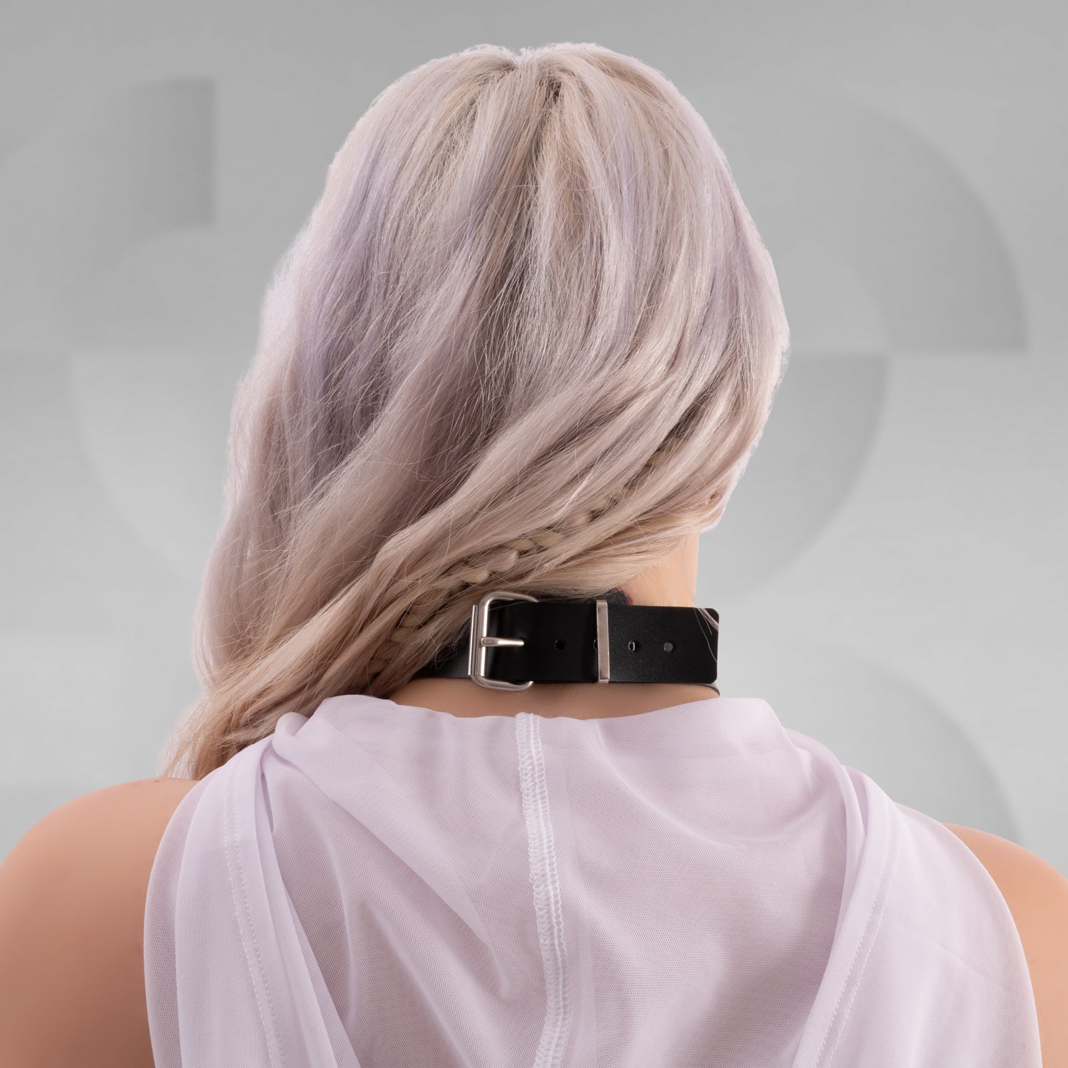 The image features a close-up of a woman wearing a bold black choker with large metallic spheres and a white sheer fabric draped around her shoulders. The overall look is edgy and statement-making, perfect for alternative fashion styles.