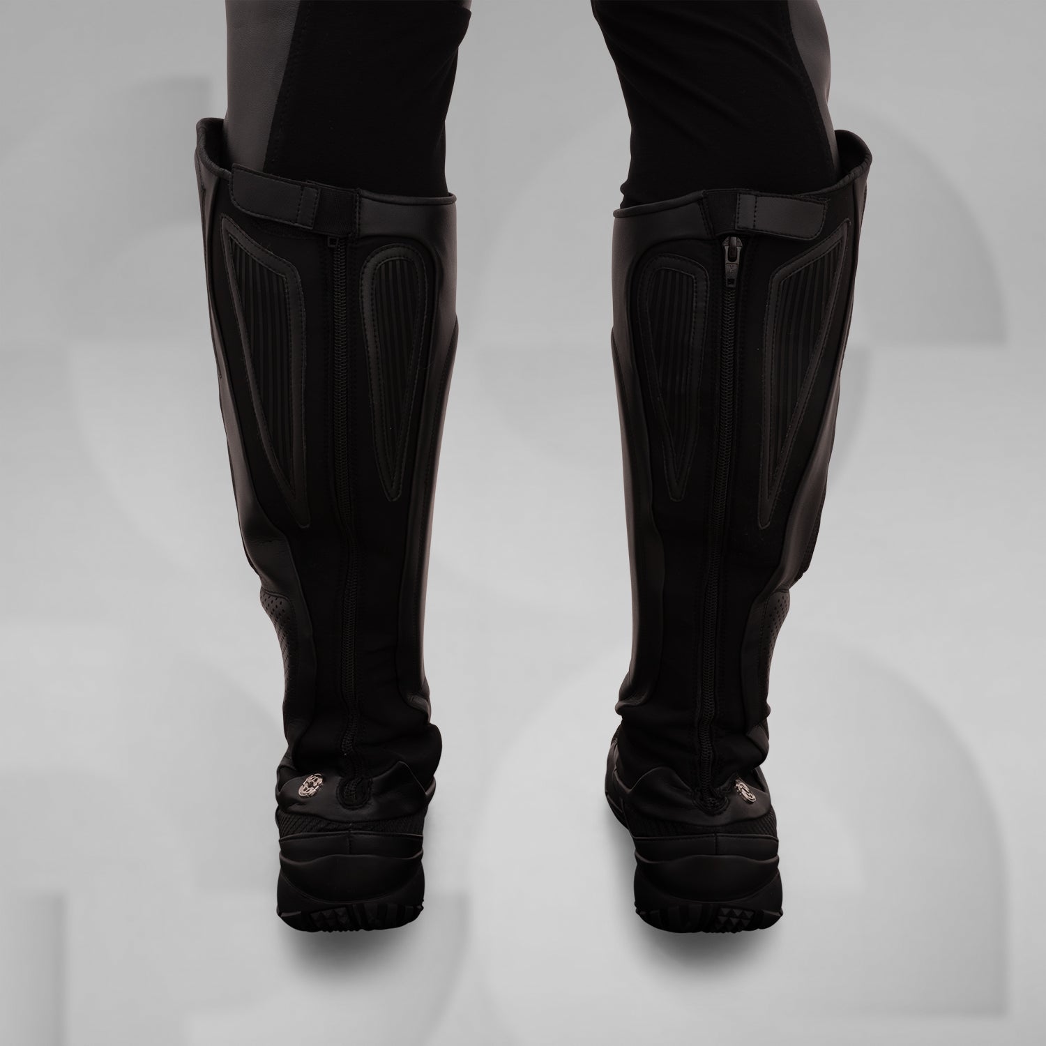 The image features sleek, futuristic black boots with a high, protective design. These avant-garde boots boast textured panels and reinforced sections, combining style and functionality. Ideal for fashion-forward individuals, they offer both comfort and edgy aesthetics, making them perfect for urban adventures or making a statement in any environment.