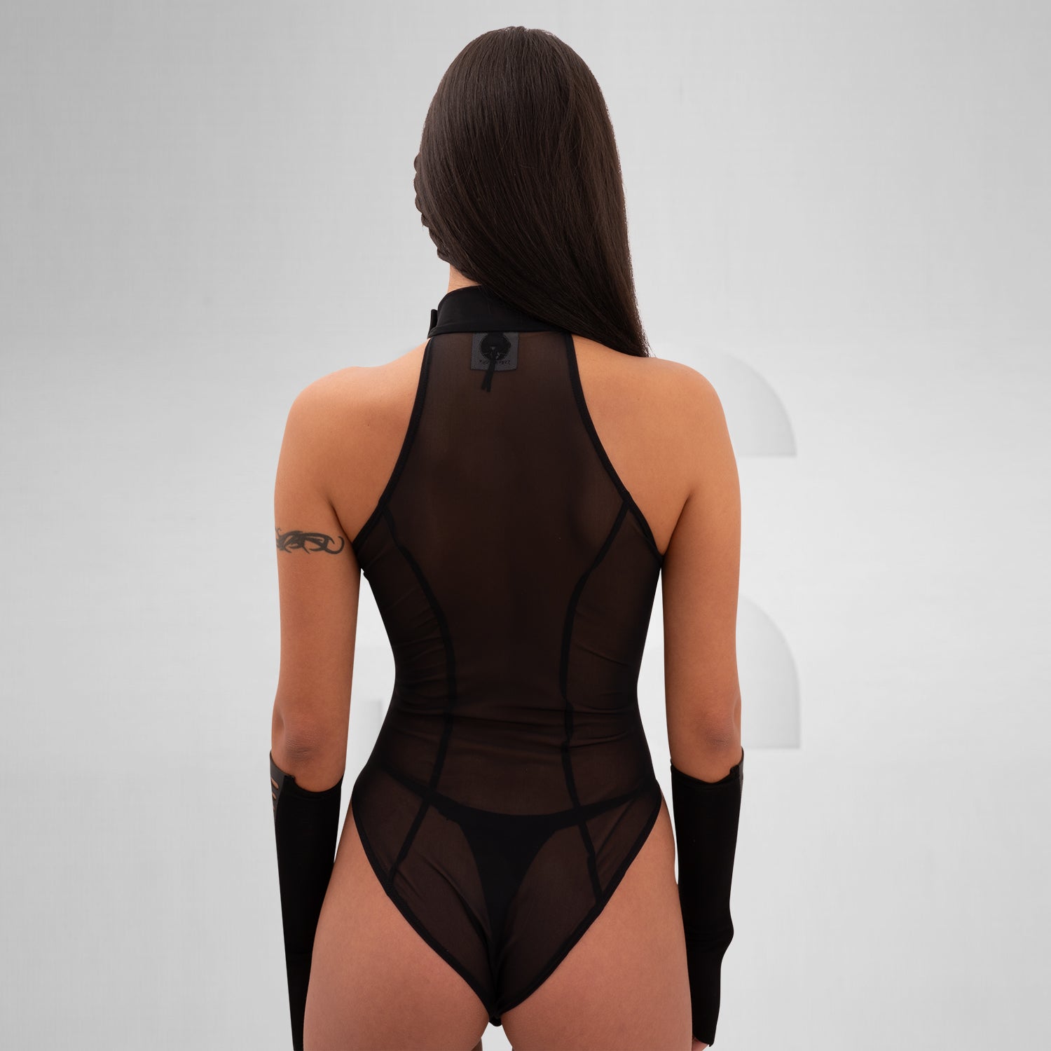 The Printed Sheer Bodysuit from Cyberesque is a striking combination of elegance and bold design. Featuring intricate laser-cut patterns that create a stunning visual impact, this bodysuit perfectly balances allure with avant-garde aesthetics. The sheer fabric elegantly hugs your curves, making it ideal for festivals, clubwear, or glamorous nights out. Complete with stylish long sleeves, this piece elevates your look, allowing you to express your unique style with confidence.