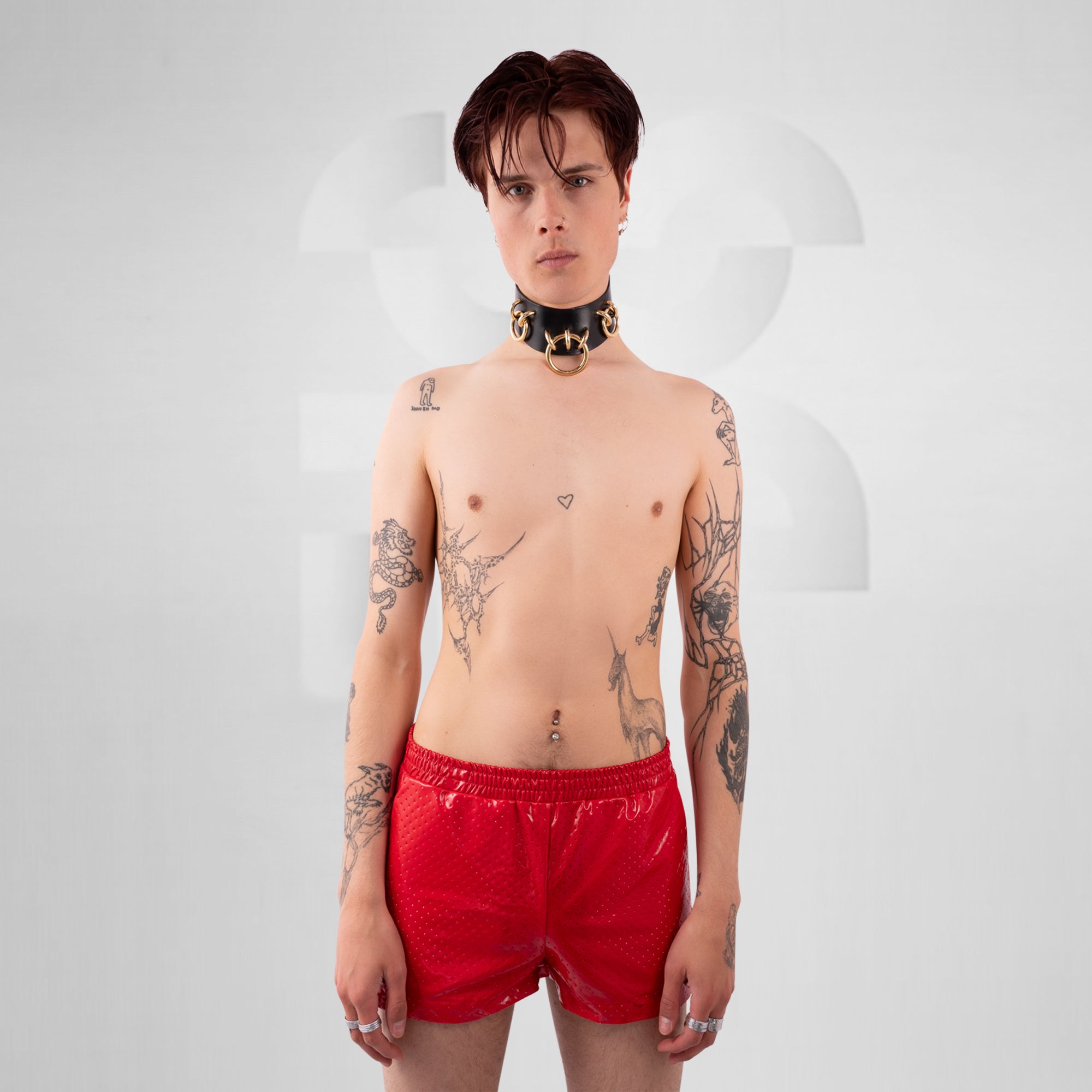 Person wearing red swim shorts on a white background