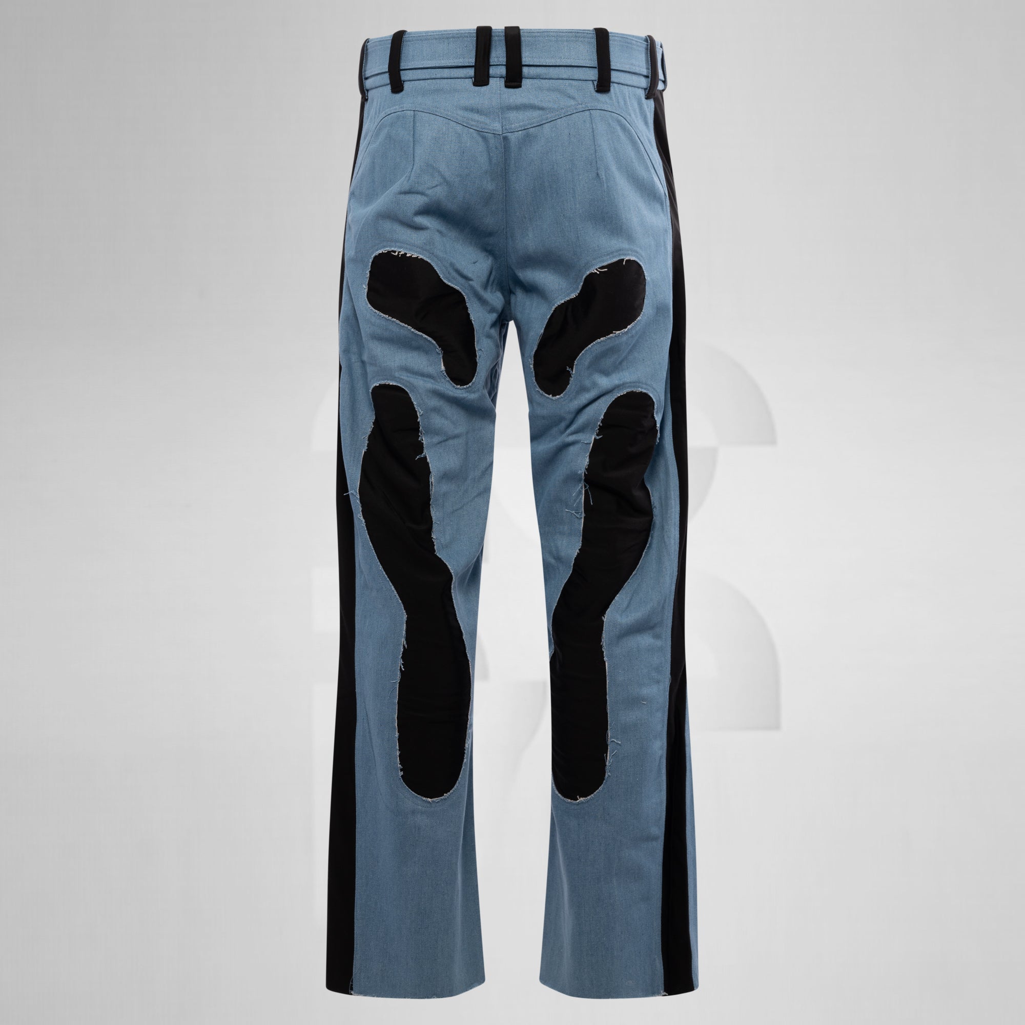 Blue pants with black patches on a gray background