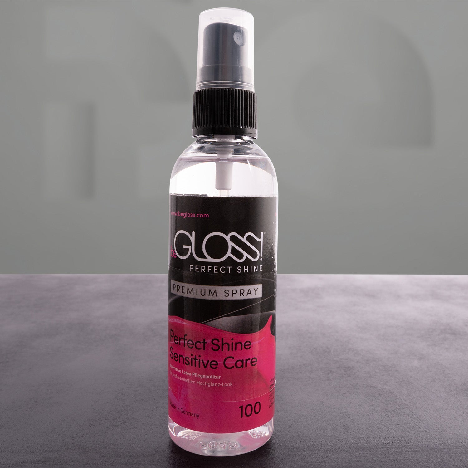 bottle with latex shine spray in front of a grey background