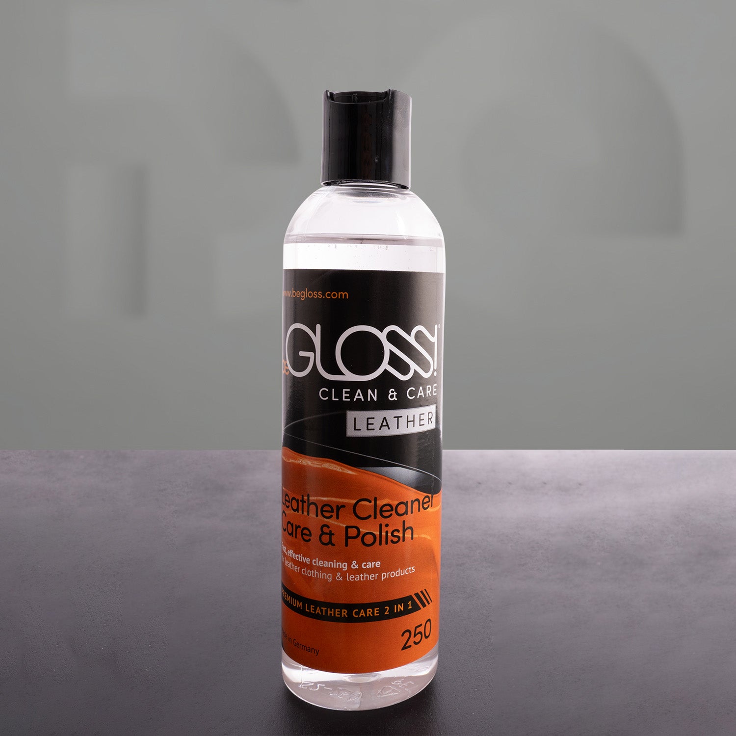leather polish bottle in front of a grey background