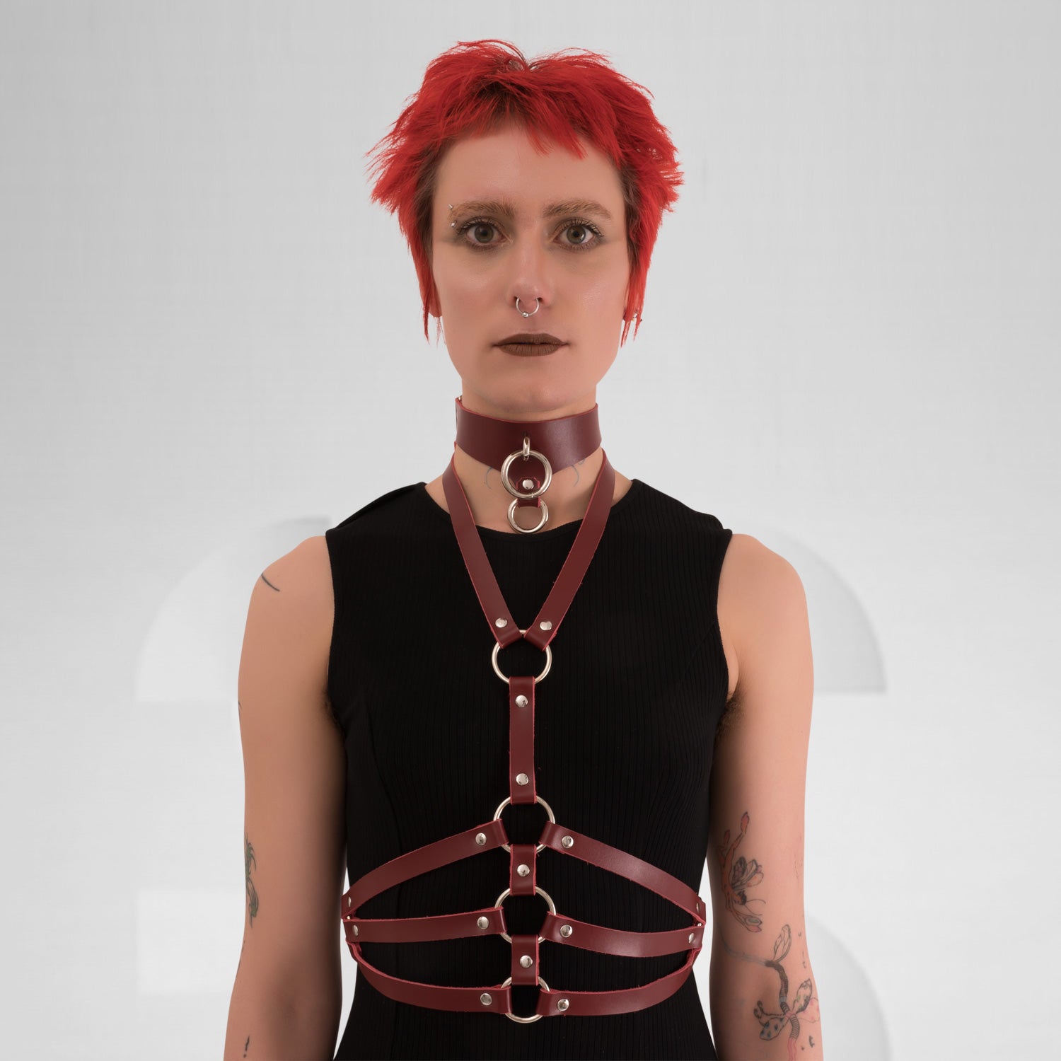 Red wine leather waist harness with silver details, perfect for a techno club scene outfit