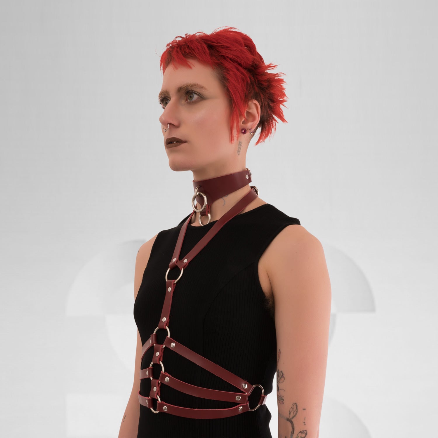 Red wine leather waist harness with silver details, perfect for a techno club scene outfit